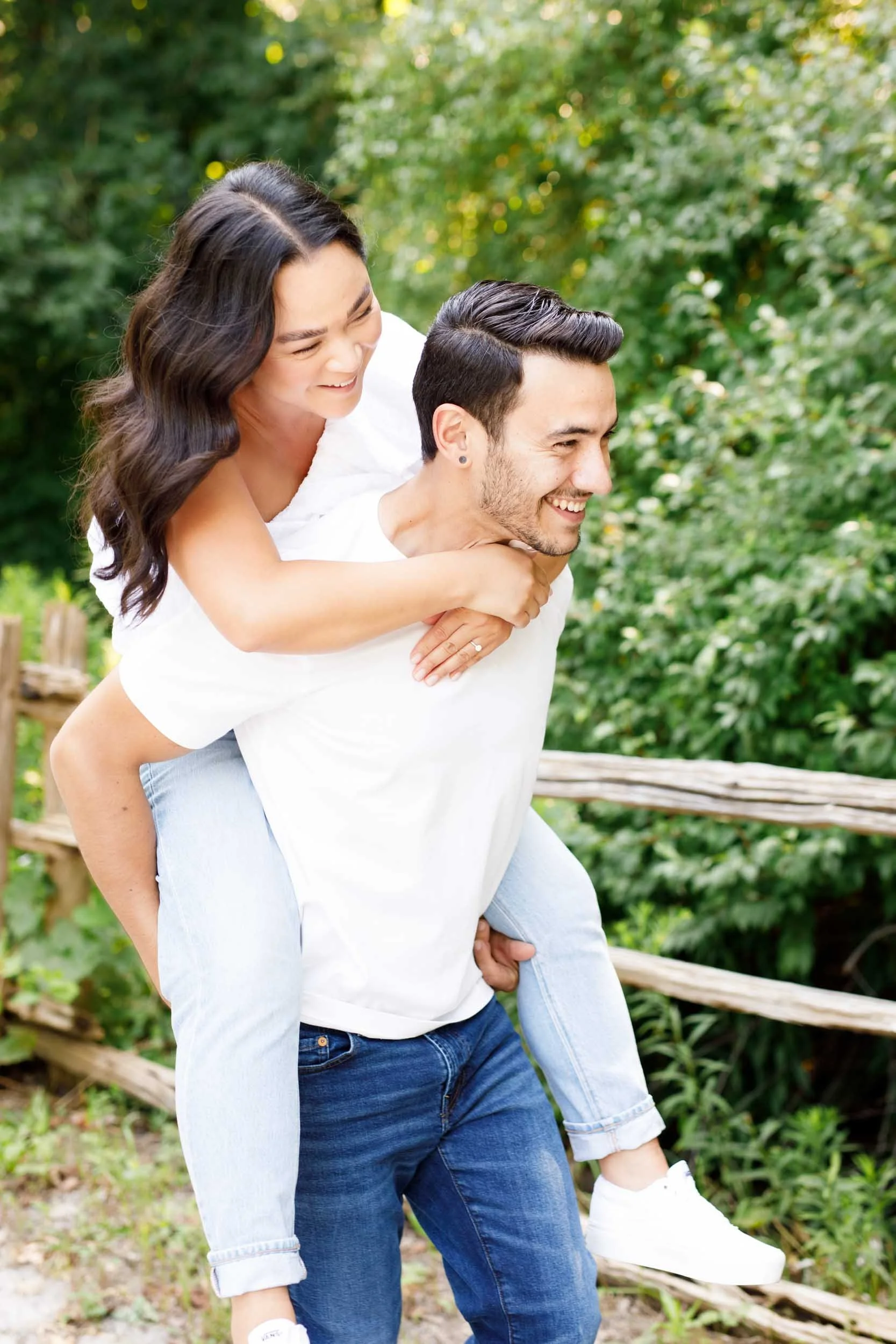 Bride riding on groom’s back during Kortright Centre engagement photos in Woodbridge, Ontario