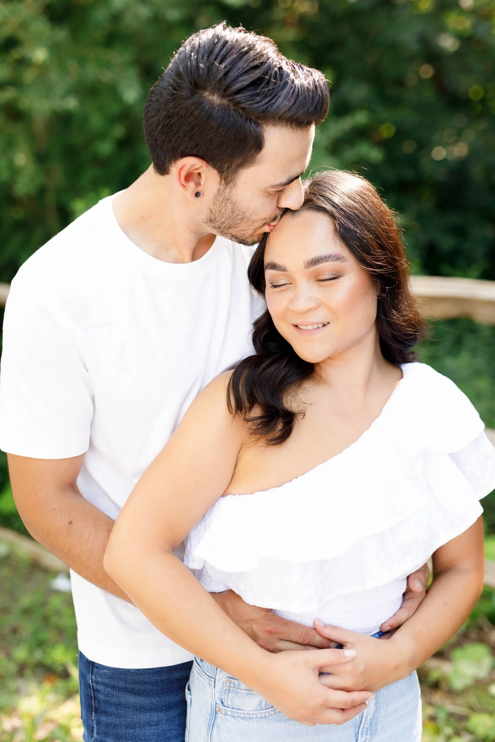Groom kissing bride’s forehead during Kortright Centre engagement session in Woodbridge, Ontario
