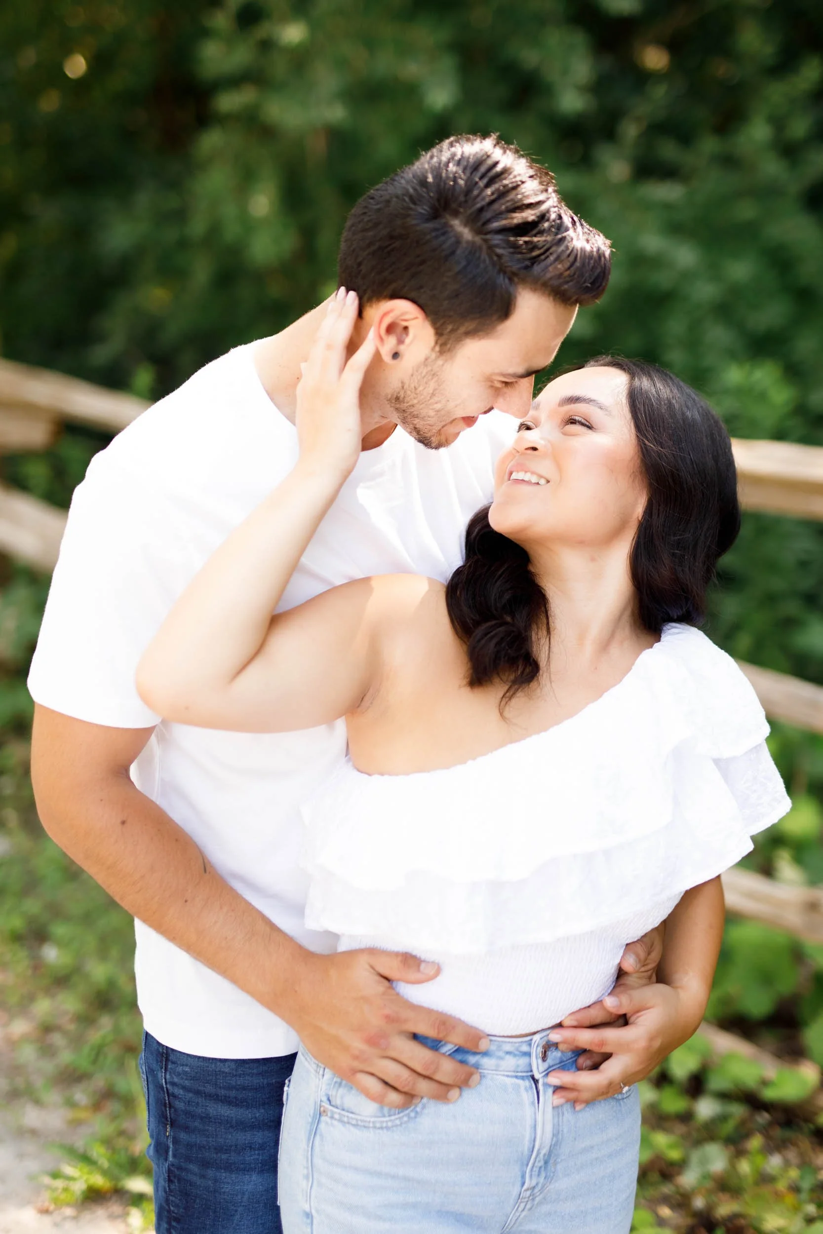 Couple cuddling under trees at Kortright Centre for Conservation in Woodbridge, Ontario