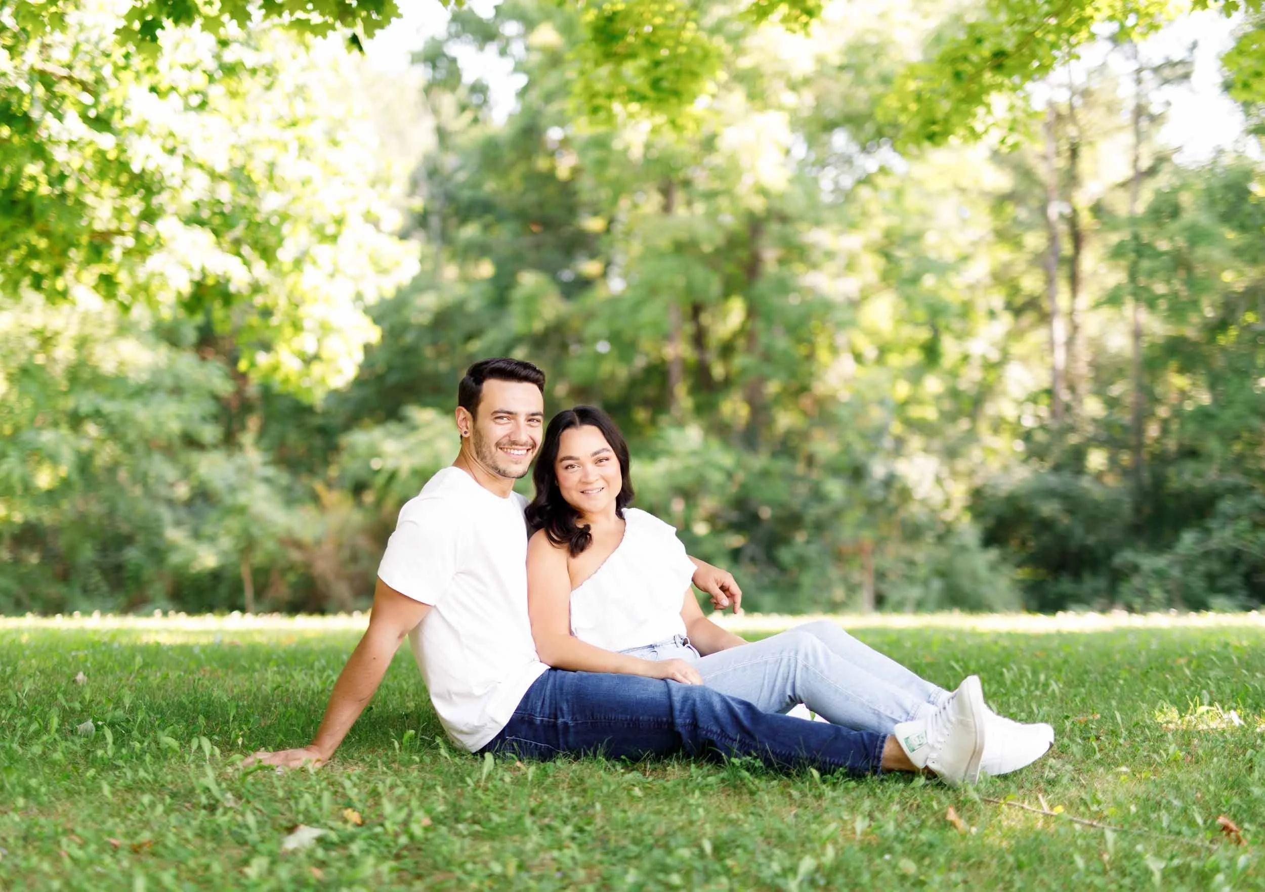 Wide meadow portrait of engaged couple at Kortright Centre in Woodbridge, Ontario