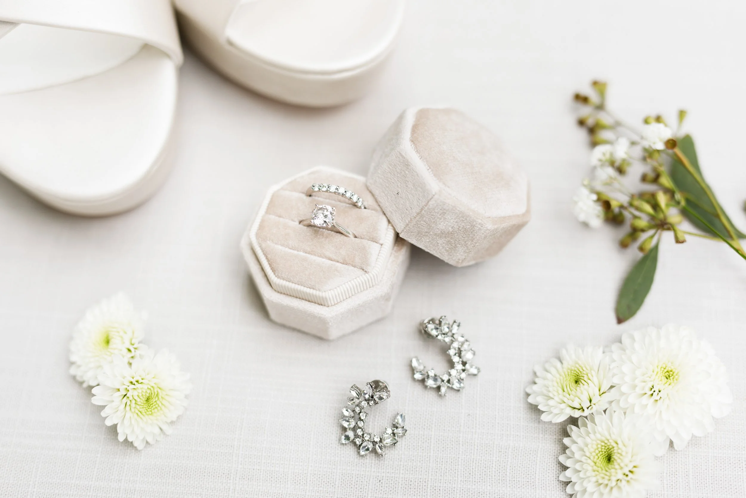 Bridal rings, earrings, and floral details photographed for a Cambium Farms wedding in Alton, Ontario