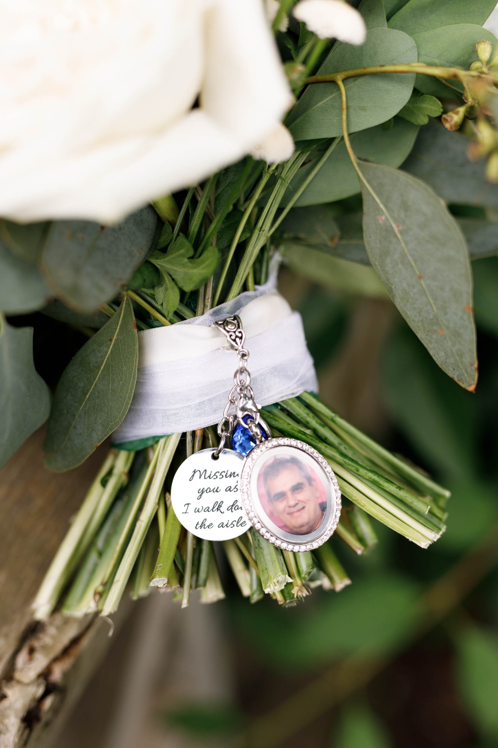 Wedding bouquet with memorial photo charms at a Cambium Farms wedding in Alton, Ontario
