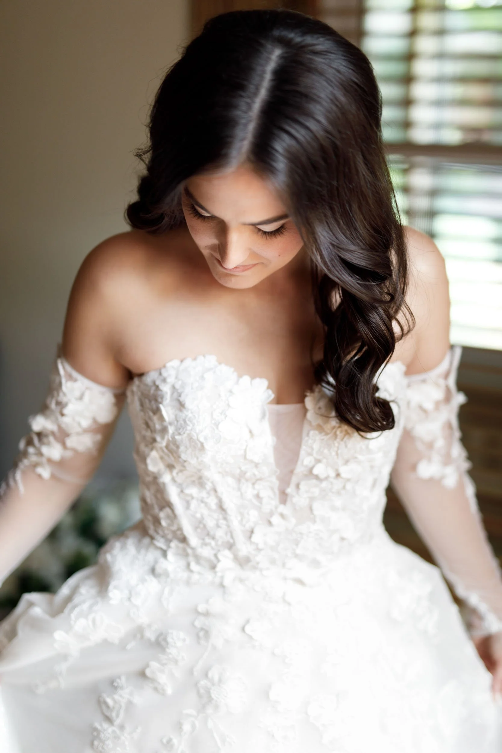 Bride adjusting her wedding dress during bridal prep at a Cambium Farms wedding in Alton, Ontario