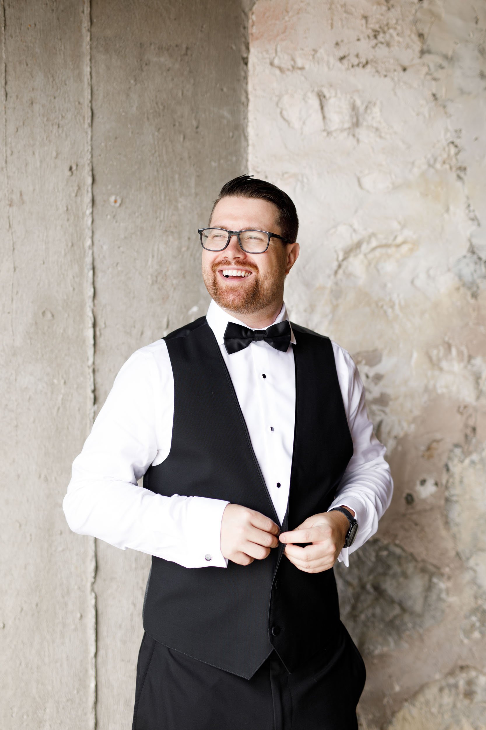 Groom smiling in his tuxedo during groom prep at a Cambium Farms wedding in Alton, Ontario