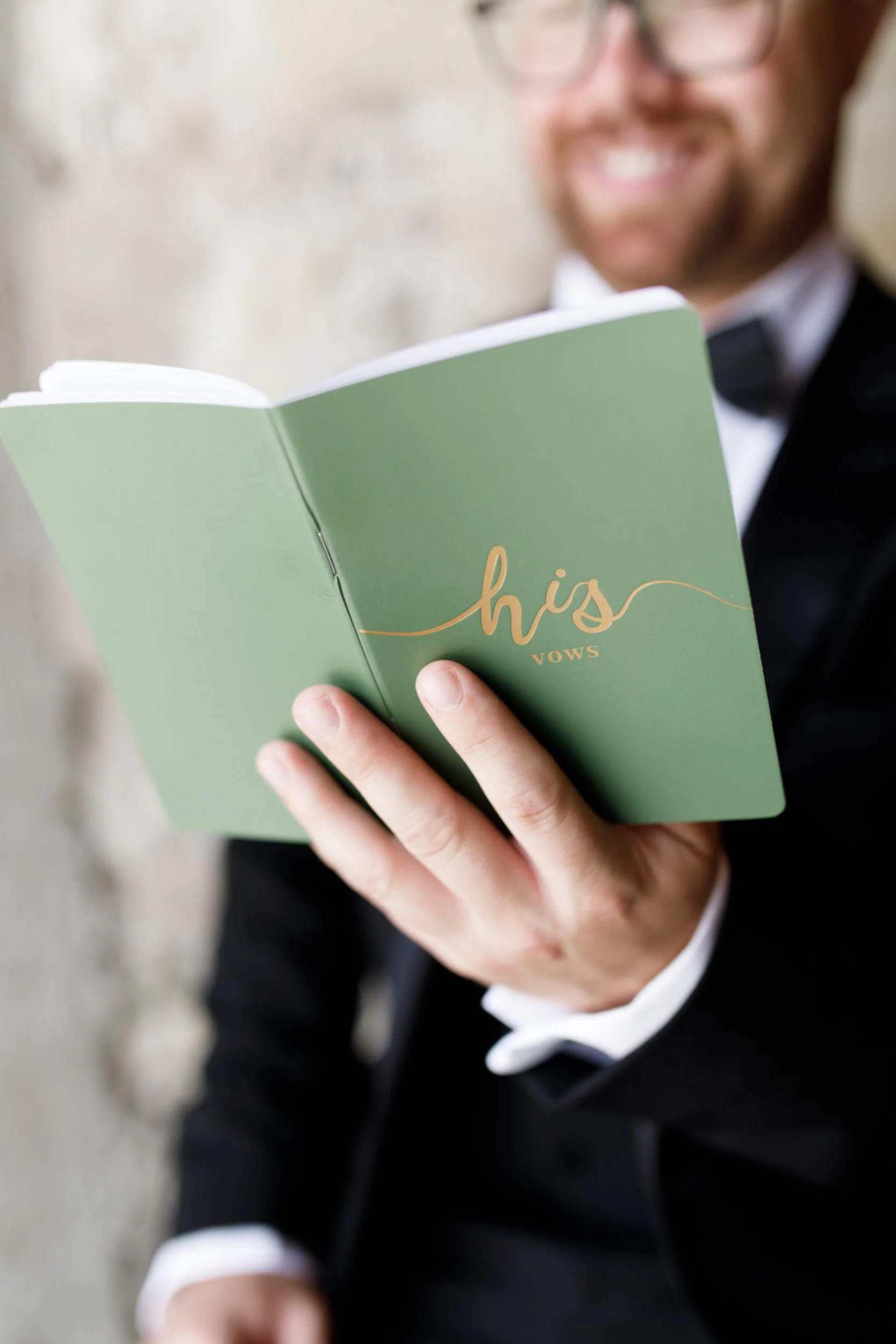 Groom holding his wedding vows booklet at a Cambium Farms wedding in Alton, Ontario