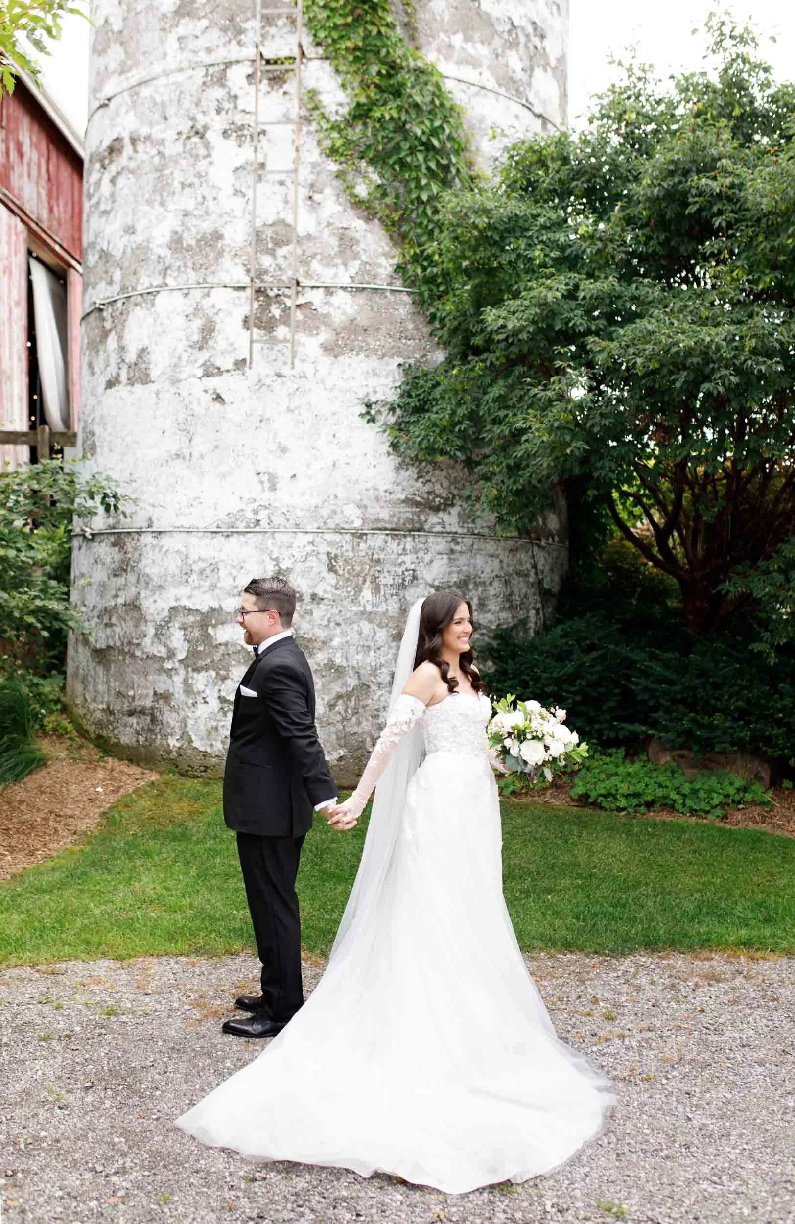 Bride and groom back to back before their first look at a Cambium Farms wedding in Alton, Ontario