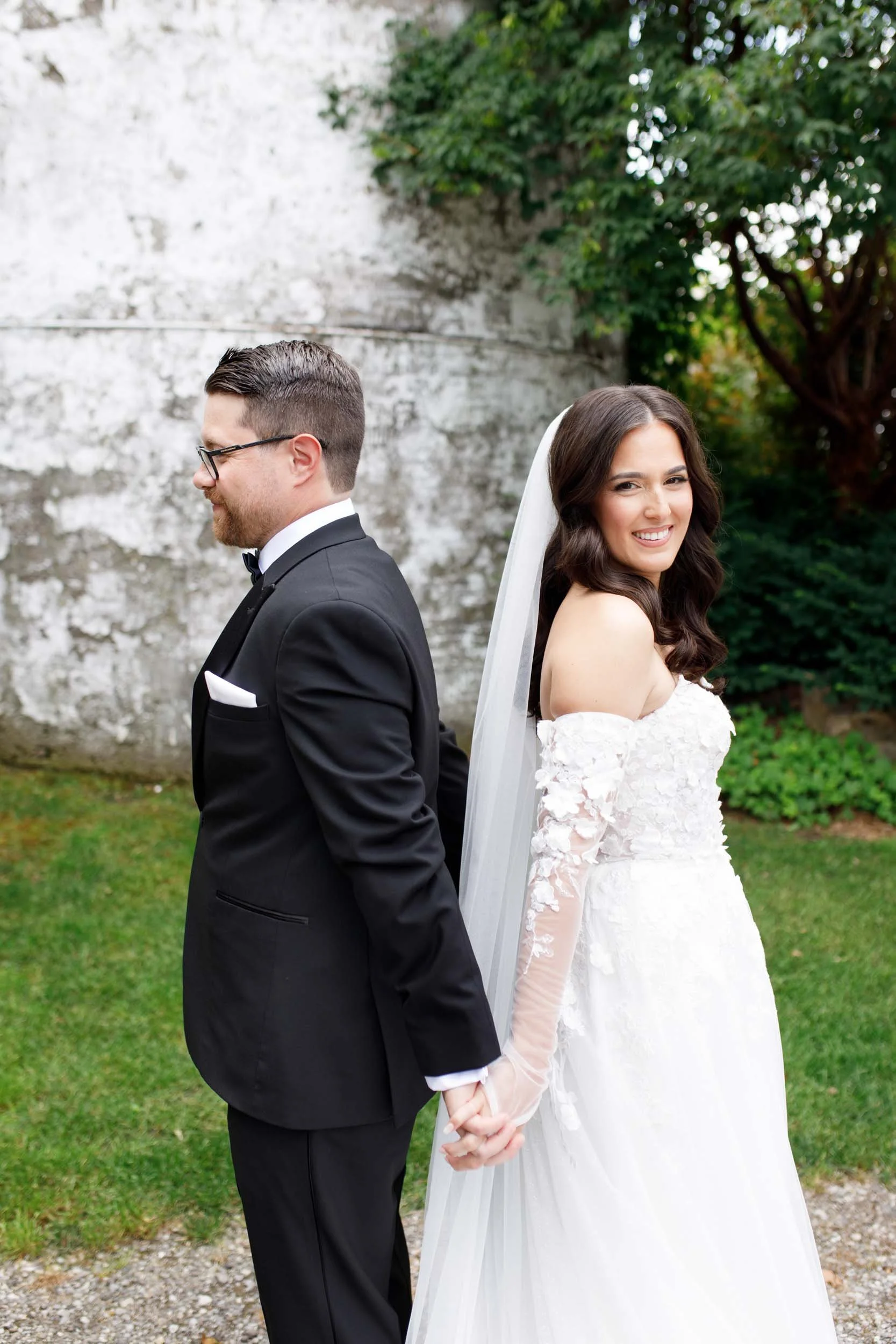 Bride and groom holding hands before their first look at Cambium Farms in Alton, Ontario