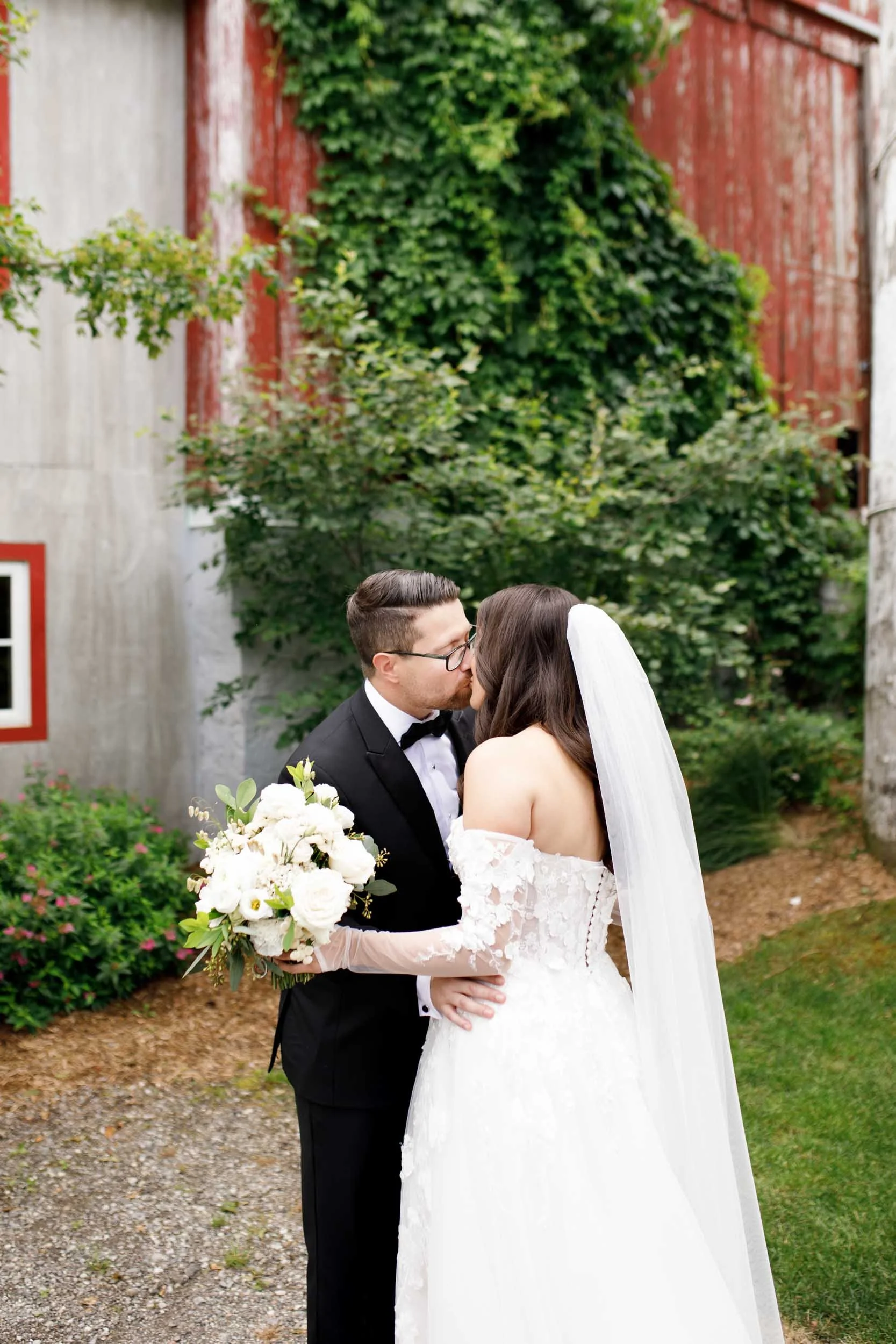 Bride and groom embracing during their first look at Cambium Farms in Alton, Ontario