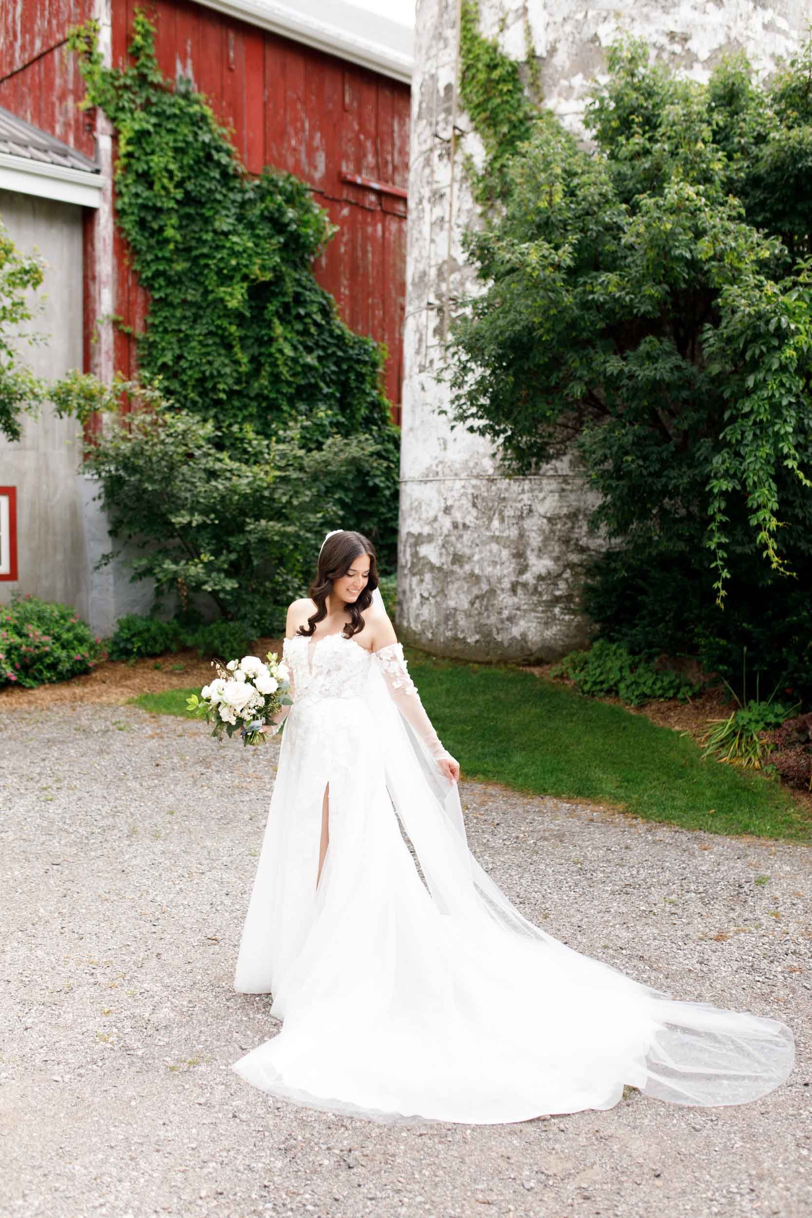 Bride walking in her wedding dress during portraits at a Cambium Farms wedding in Alton, Ontario