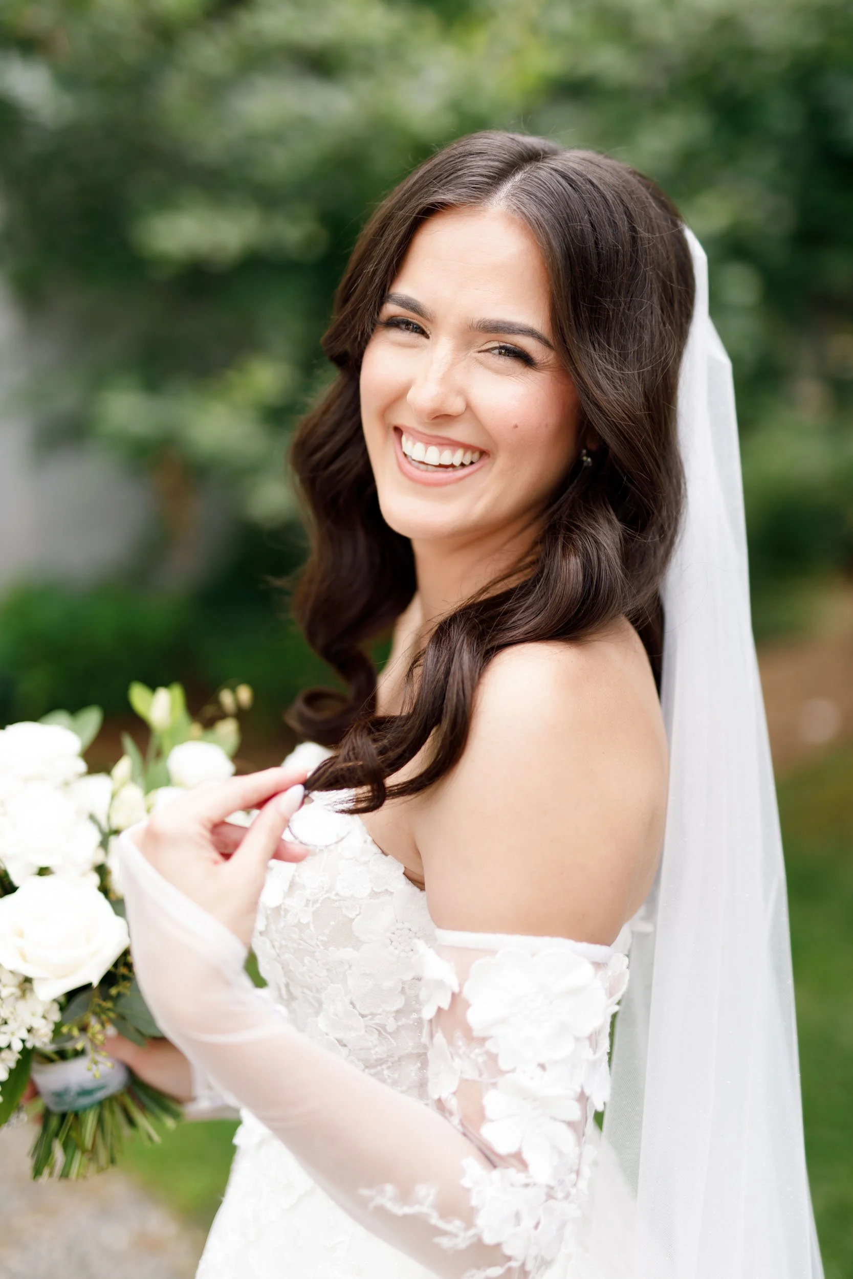 Bride smiling with her veil and bouquet during portraits at a Cambium Farms wedding in Alton, Ontario