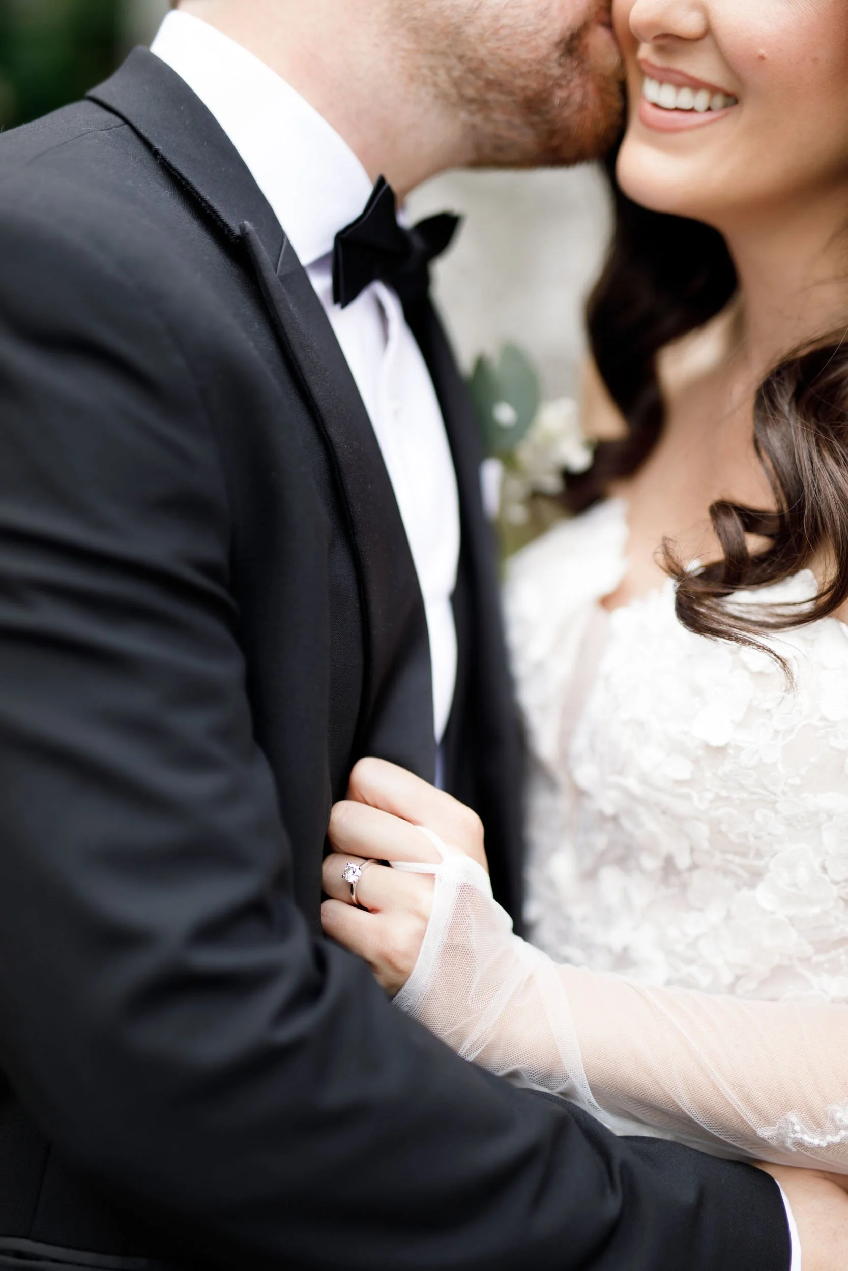 Close-up of bride and groom embracing during their Cambium Farms wedding in Alton, Ontario