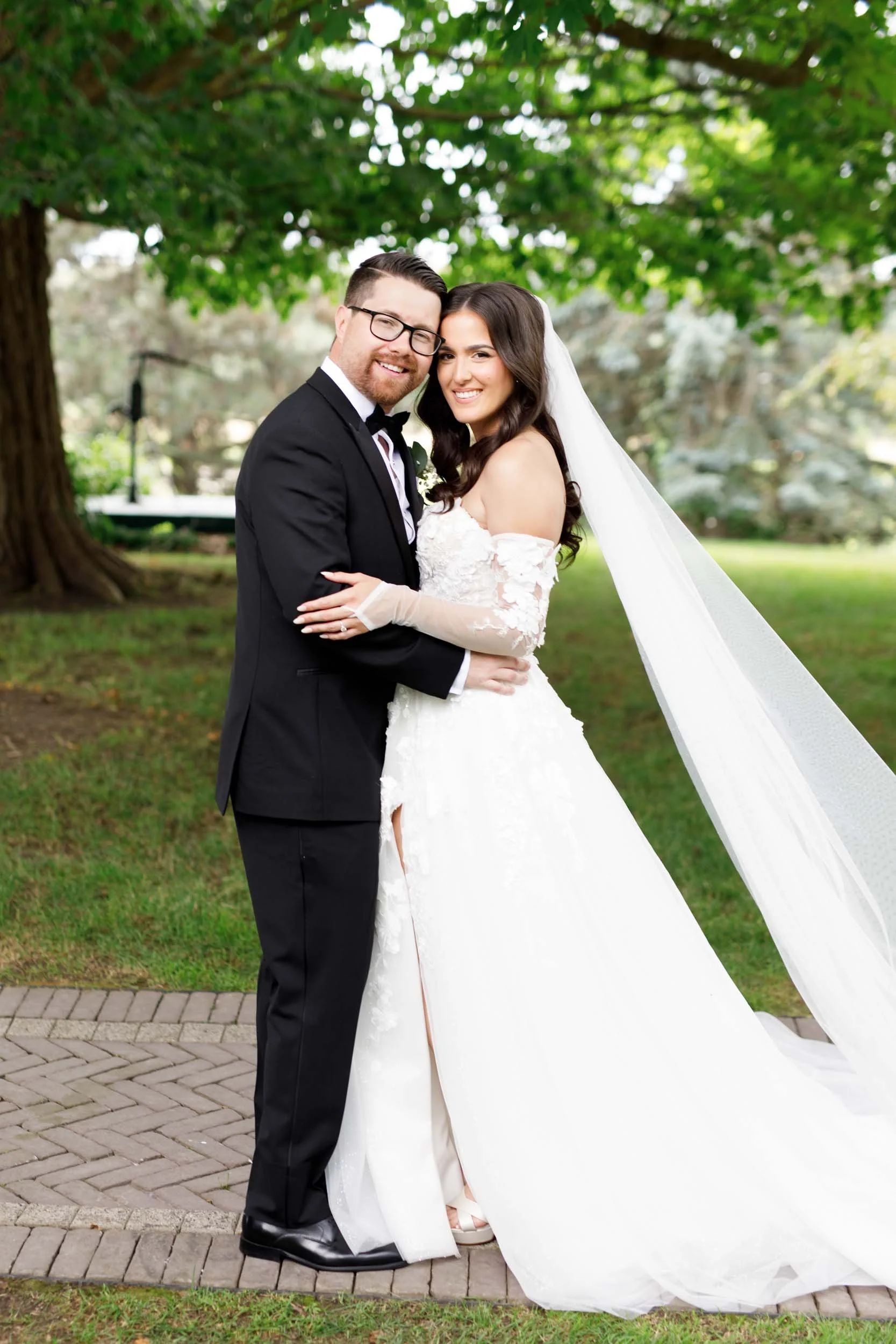 Bride and groom posing together with flowing veil at a Cambium Farms wedding in Alton, Ontario