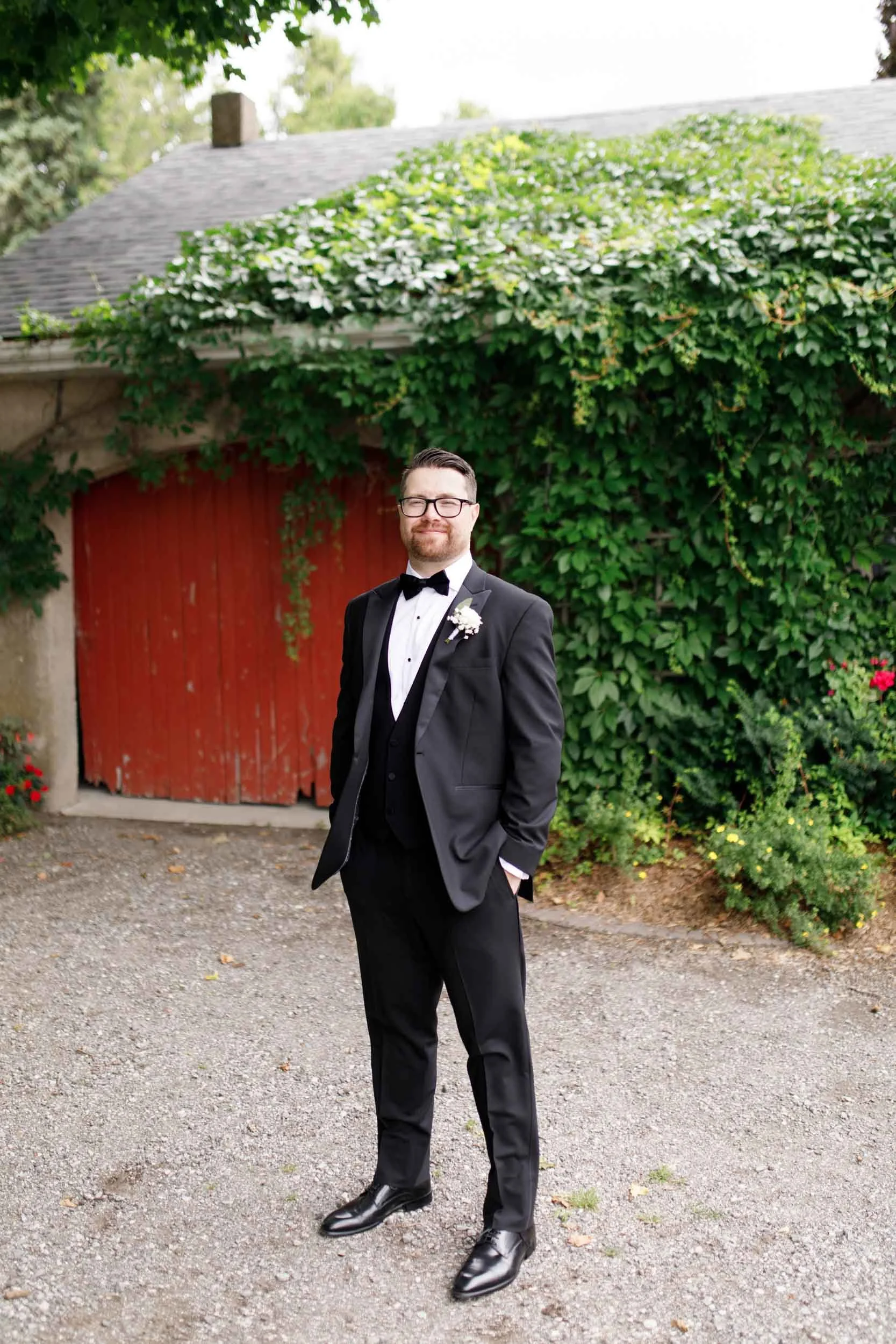 Groom standing alone for wedding portraits at a Cambium Farms wedding in Alton, Ontario