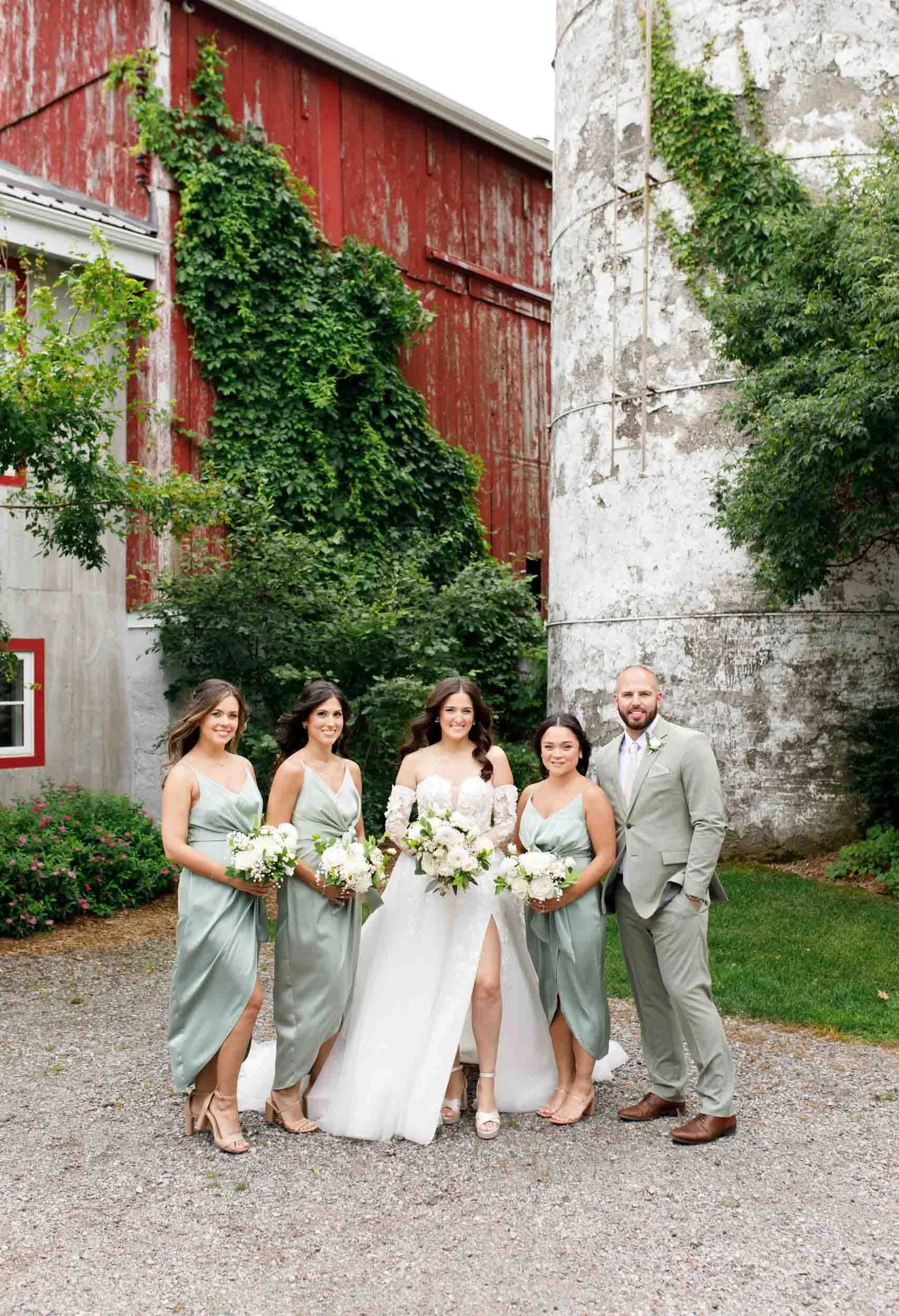 Bride and bridesmaids posing together at a Cambium Farms wedding in Alton, Ontario