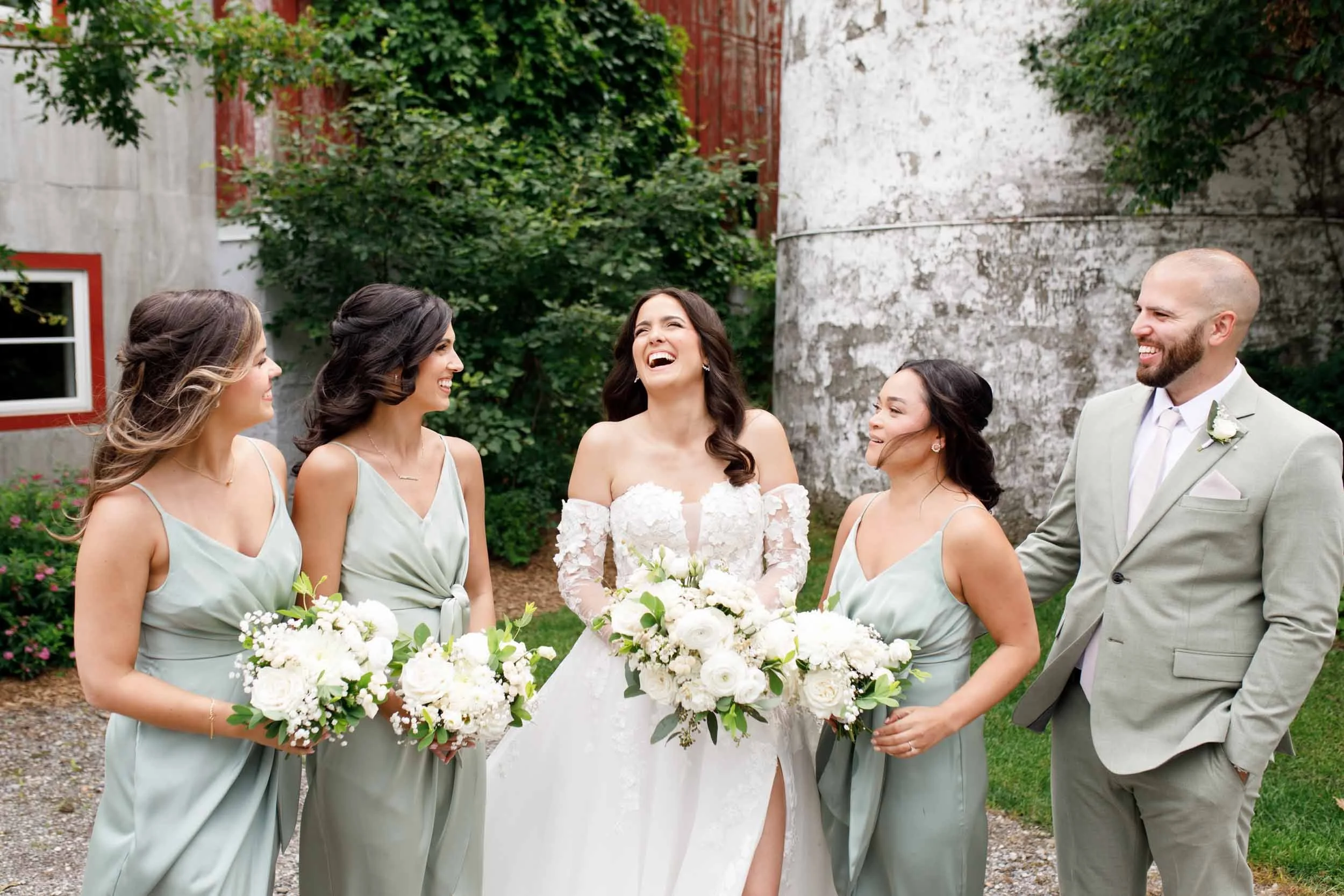 Bridal party laughing together during wedding portraits at Cambium Farms in Alton, Ontario