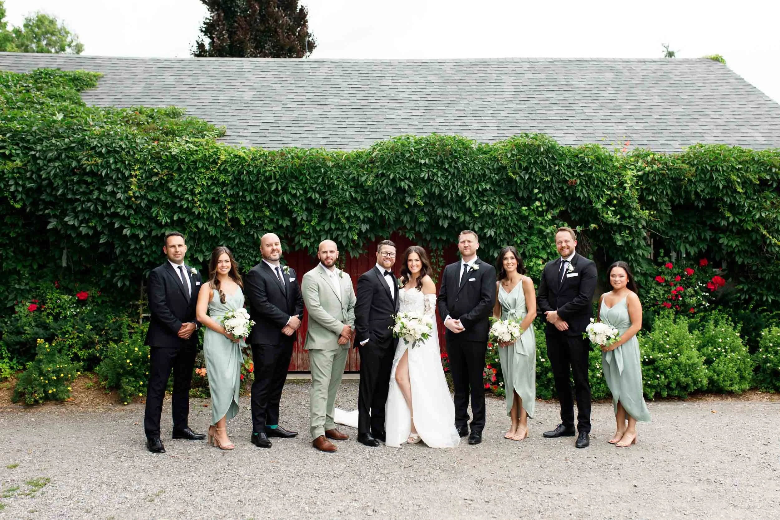 Full wedding party posing together at a Cambium Farms wedding in Alton, Ontario