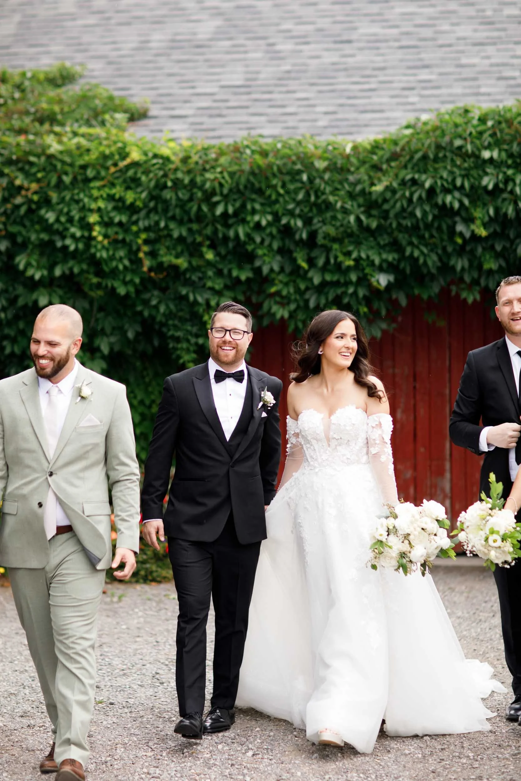 Bride and groom walking with their wedding party at a Cambium Farms wedding in Alton, Ontario