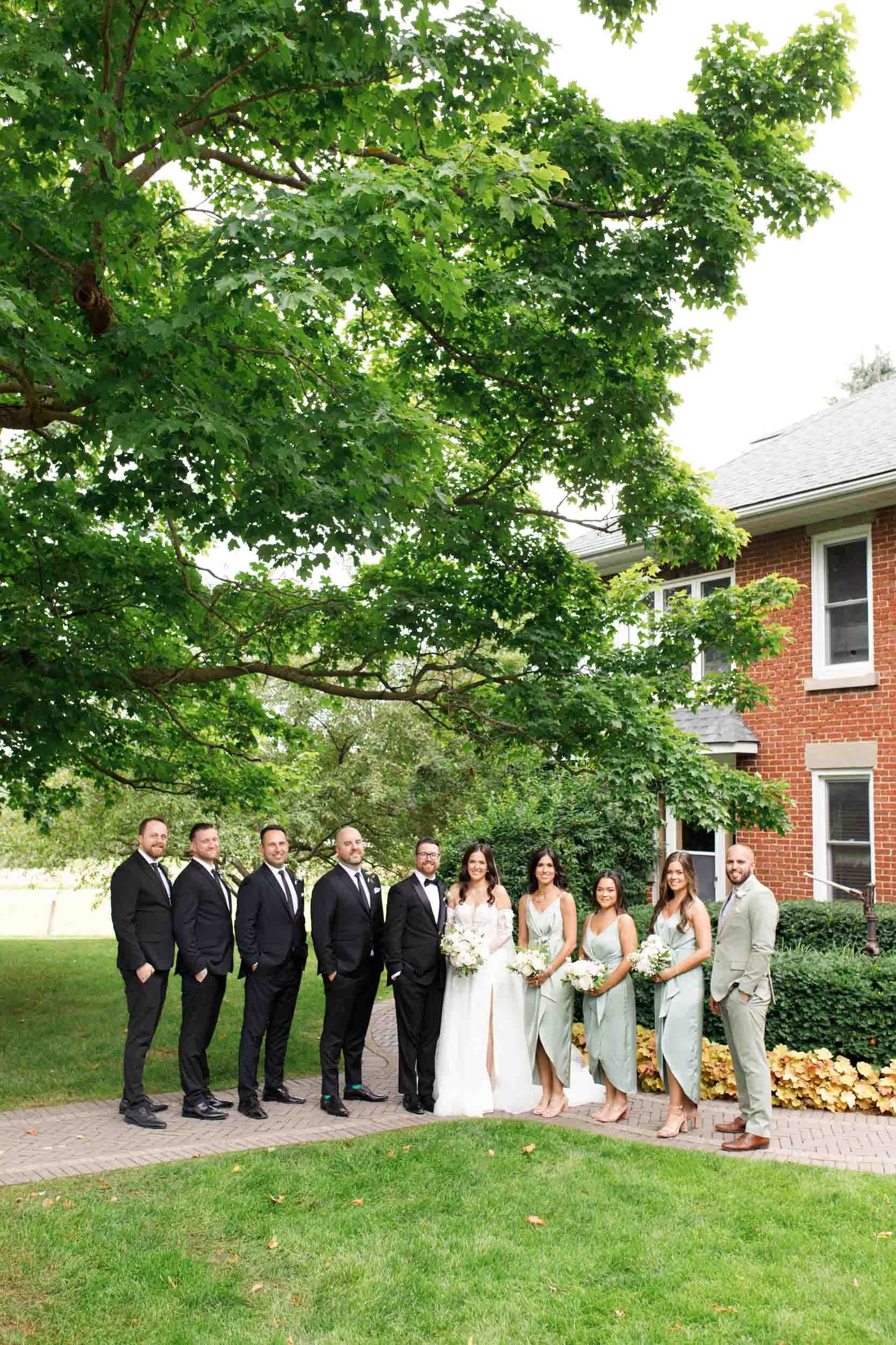 Wedding party lined up outdoors at a Cambium Farms wedding in Alton, Ontario