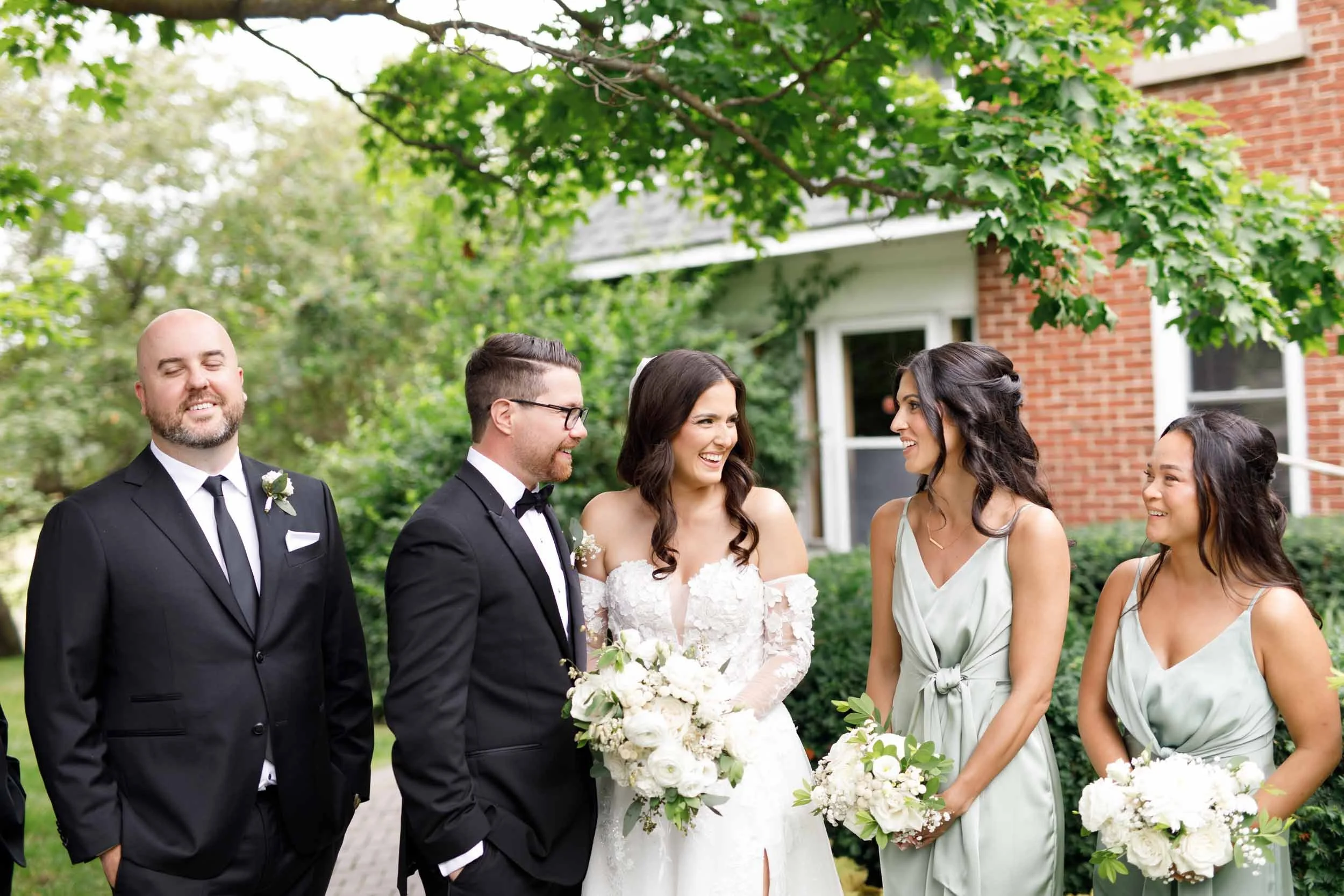 Bride and groom walking with bridesmaids and groomsmen at Cambium Farms in Alton, Ontario
