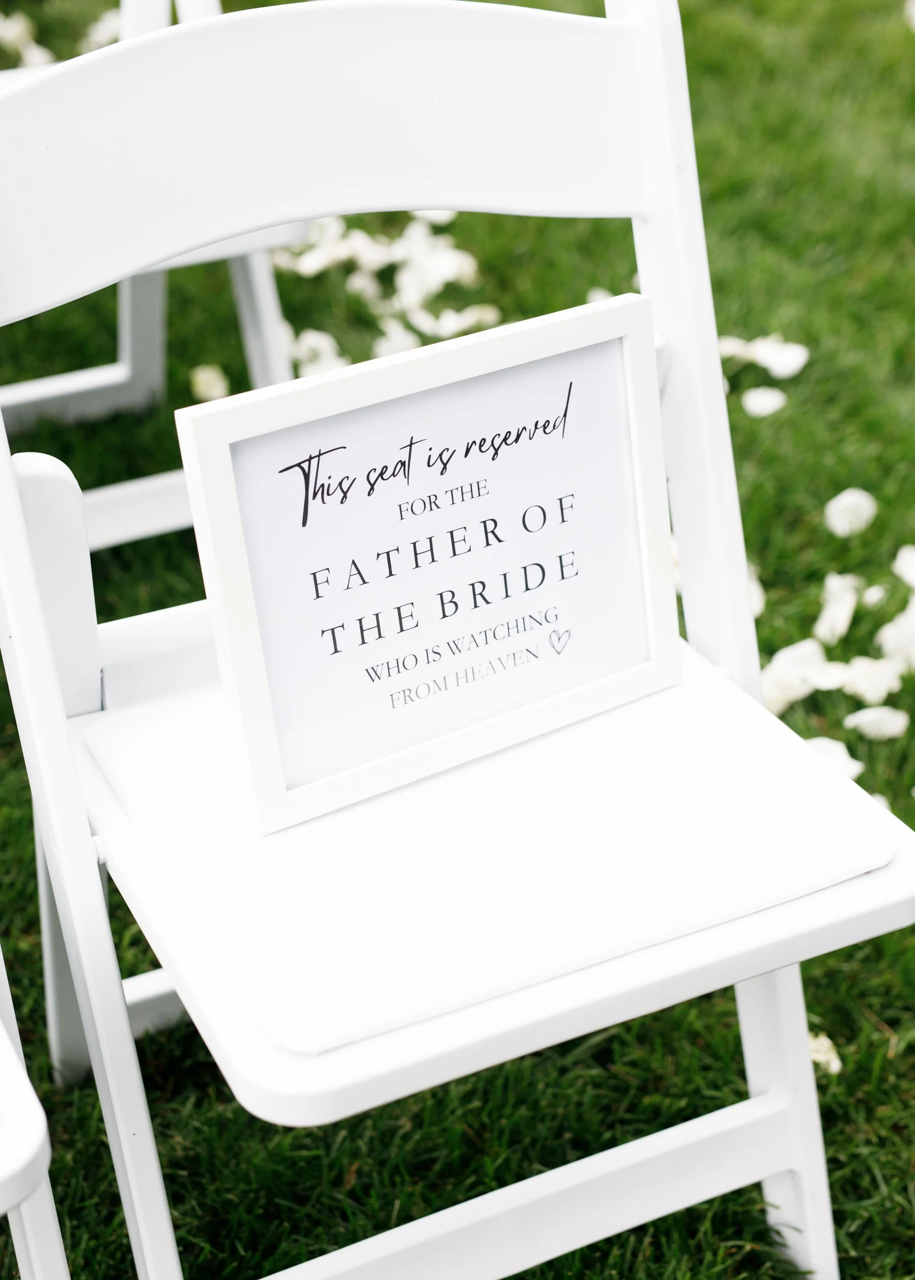 Reserved father of the bride chair at an outdoor Cambium Farms wedding in Alton, Ontario