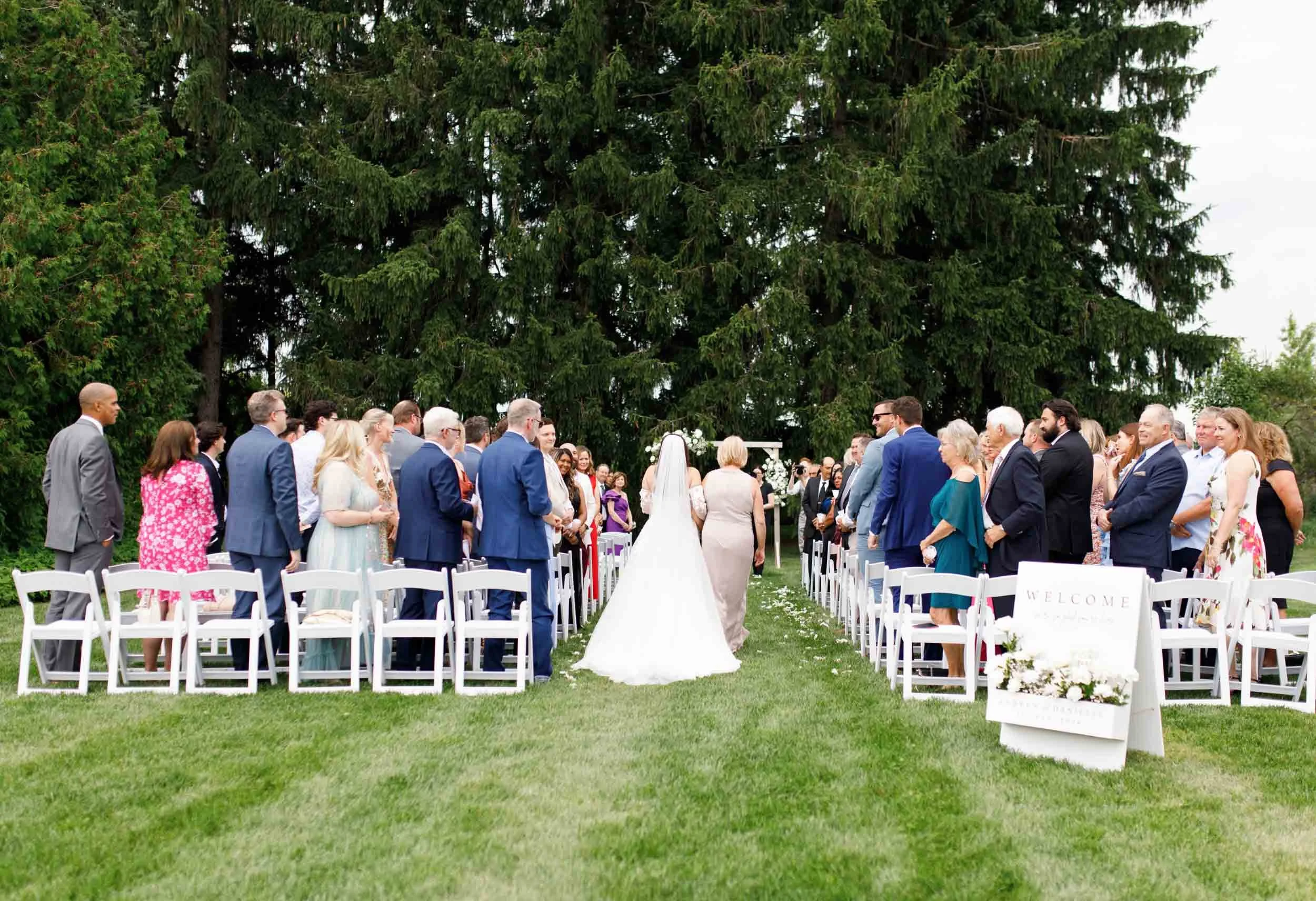Guests standing for bride at an outdoor wedding ceremony at Cambium Farms in Alton, Ontario