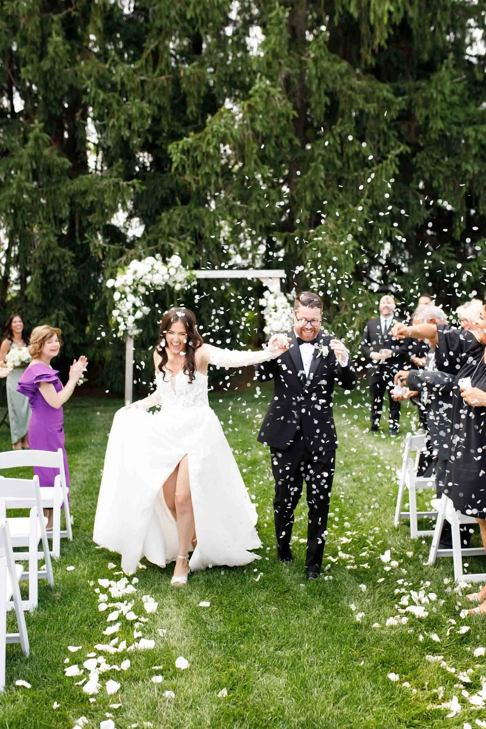 Bride and groom walking back up the aisle after the ceremony at Cambium Farms in Alton, Ontario