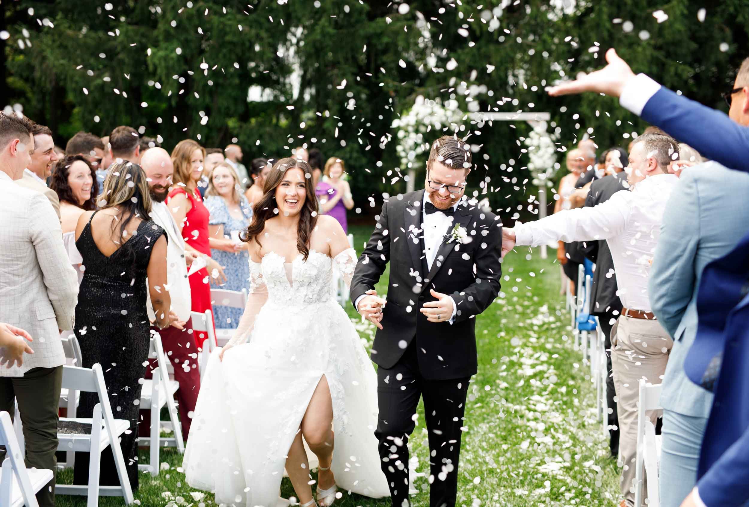 Bride and groom smiling as guests celebrate their ceremony at Cambium Farms in Alton, Ontario