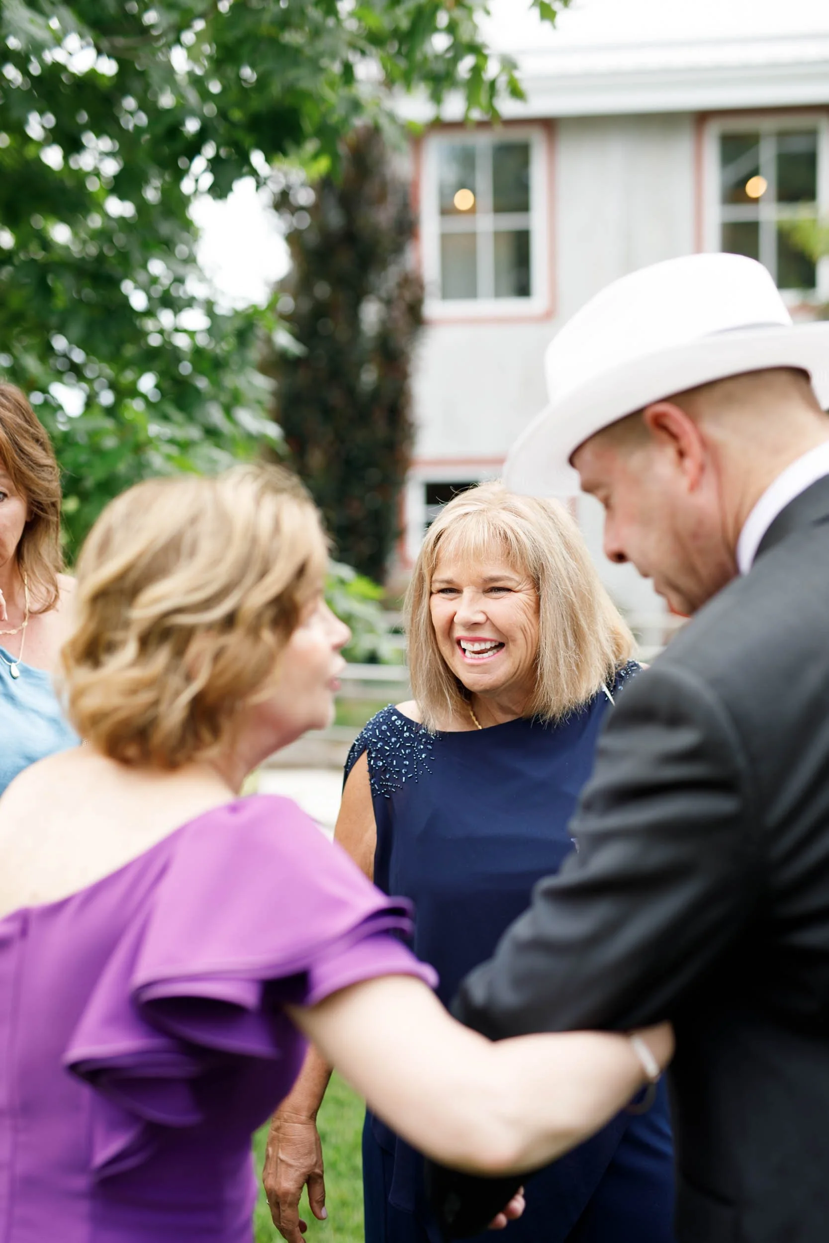 Wedding guests greeting each other during cocktail hour at Cambium Farms in Alton, Ontario