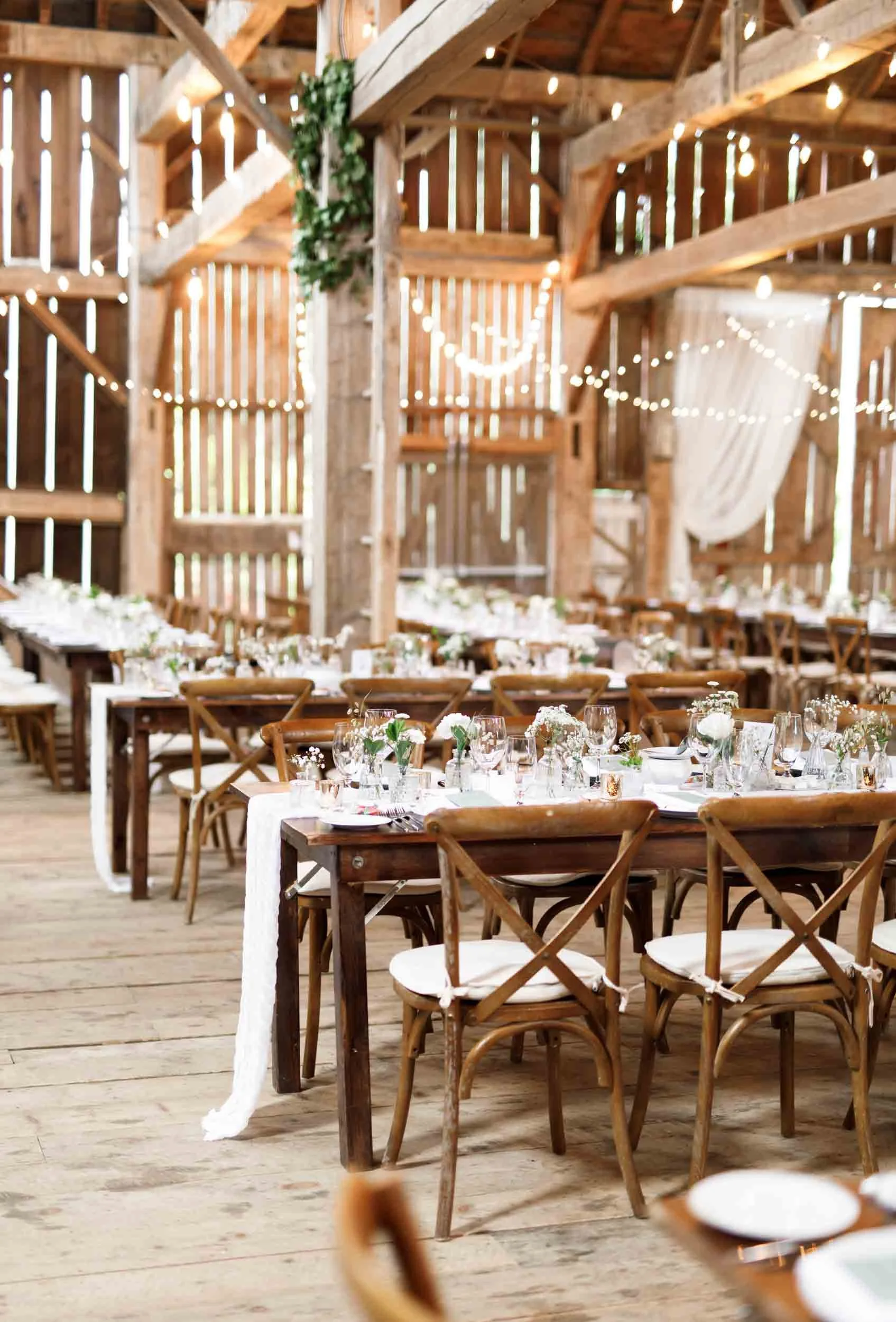 Rustic barn wedding reception tables at Cambium Farms in Alton, Ontario
