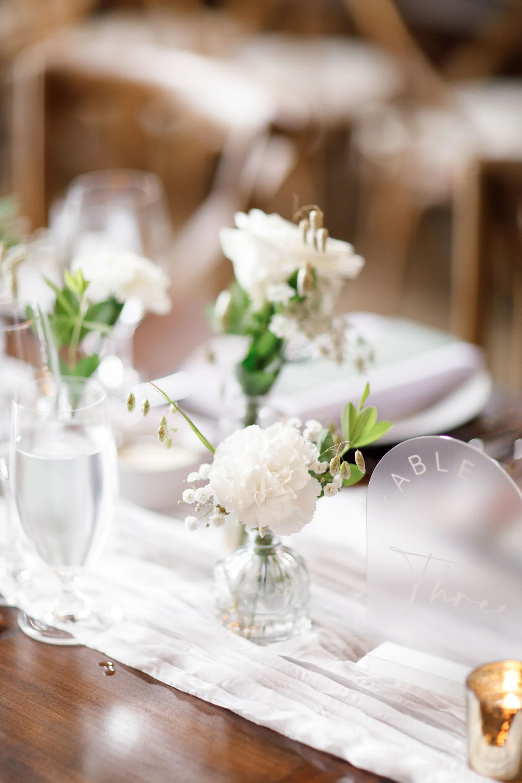 Wedding table centrepiece and floral décor inside the Cambium Farms barn in Alton, Ontario