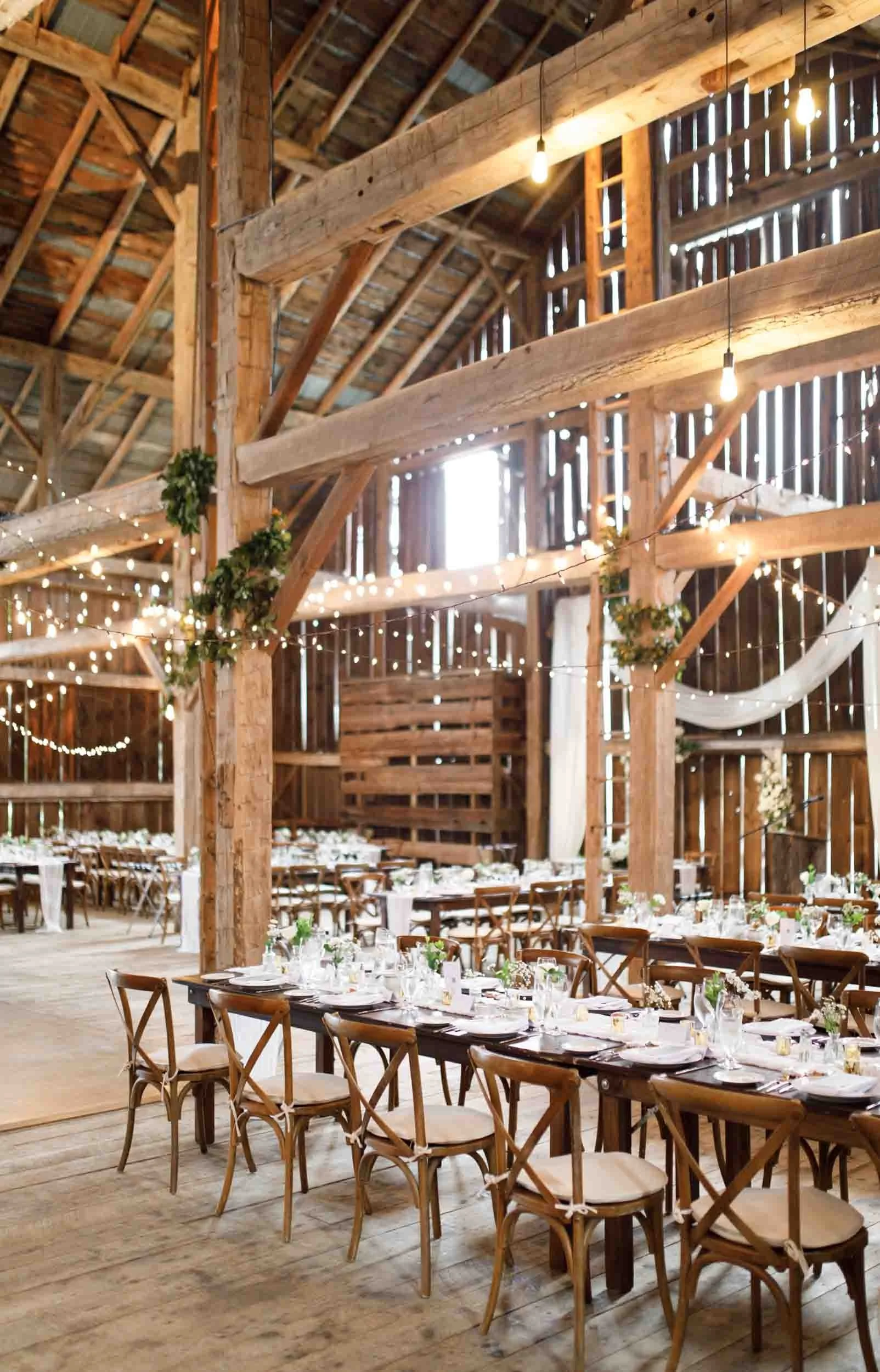 Wide view of the Cambium Farms barn set up for a wedding reception in Alton, Ontario