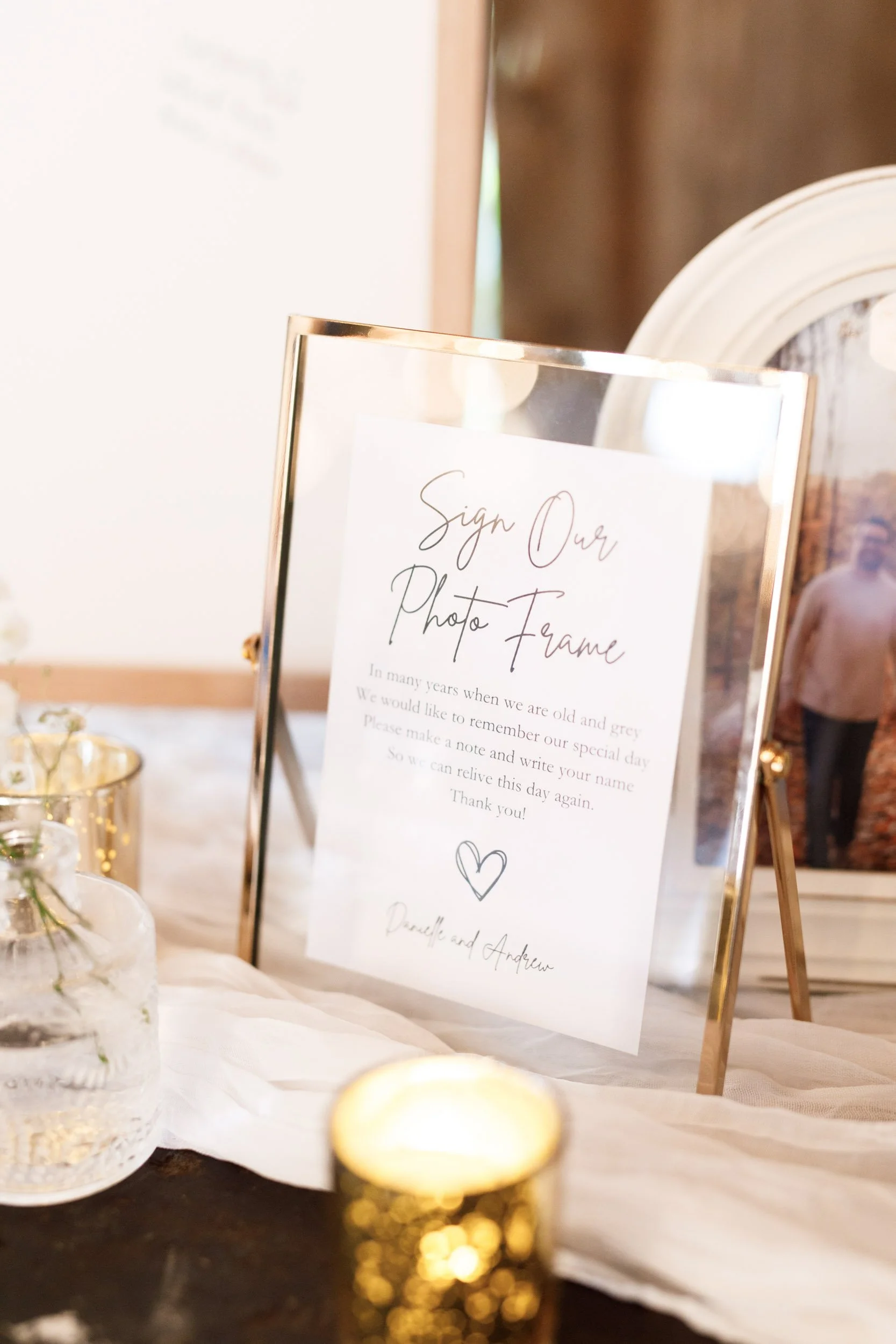 Wedding signage and candle décor inside the Cambium Farms barn in Alton, Ontario