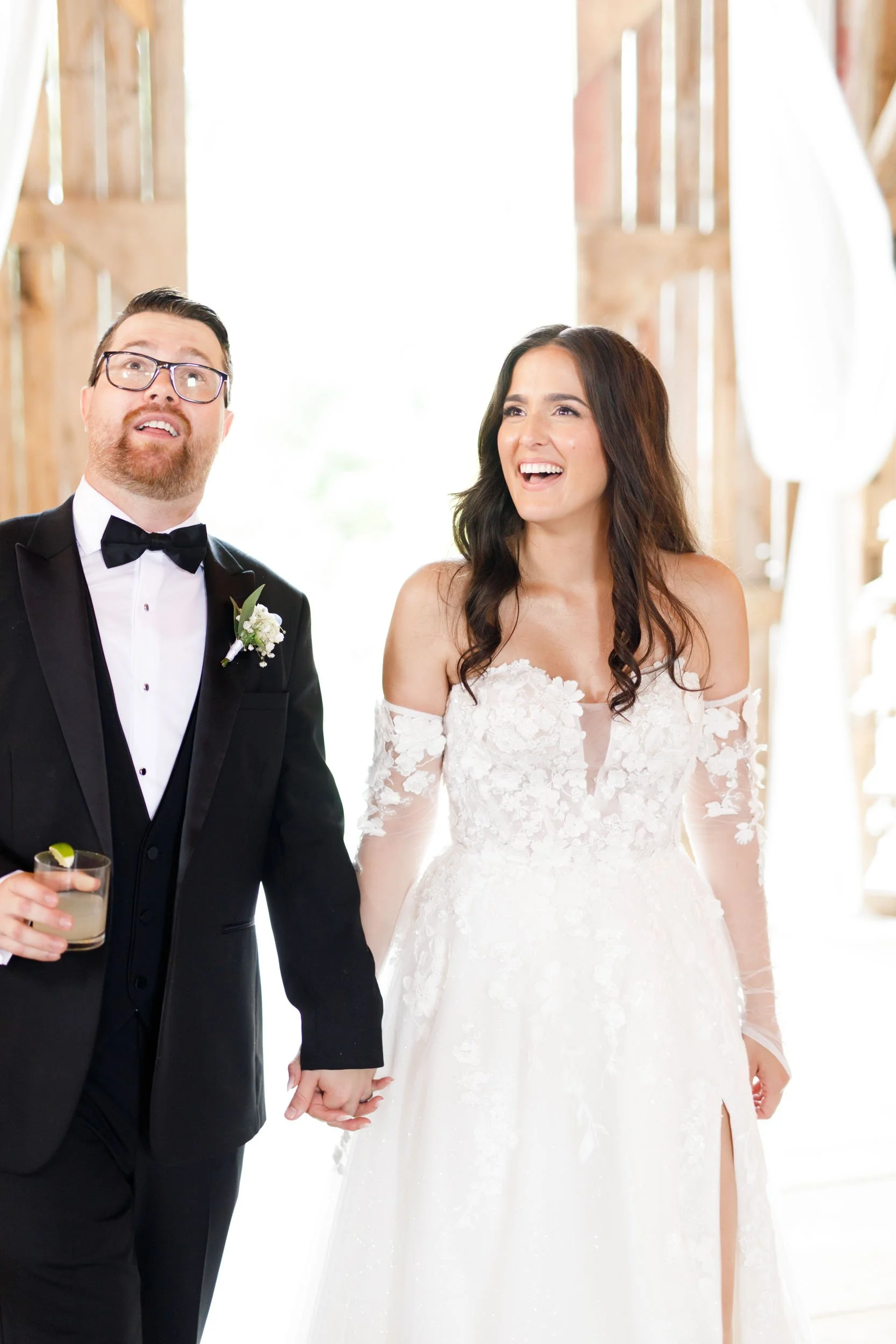 Bride and groom smiling during their reception entrance at Cambium Farms in Alton, Ontario