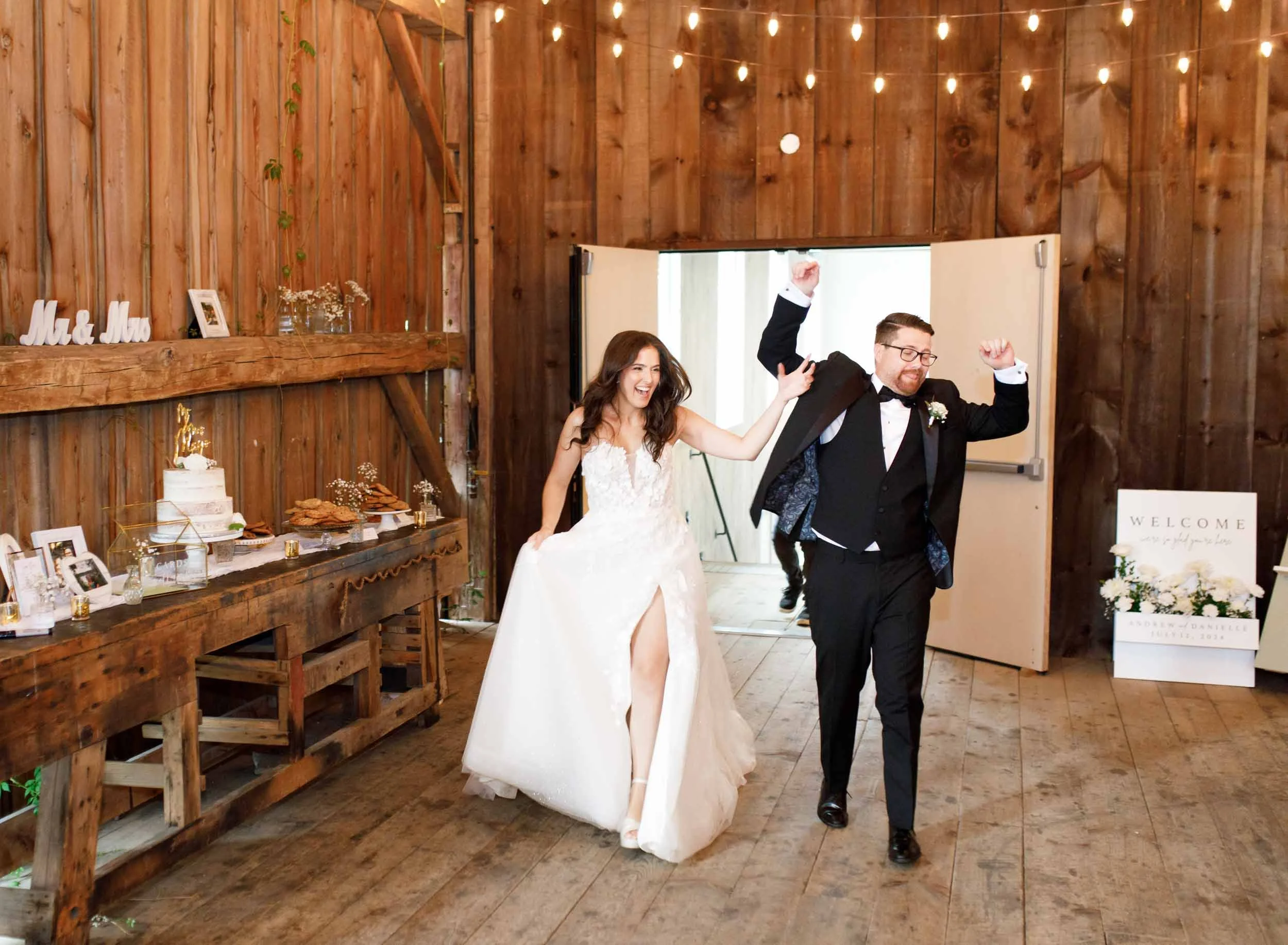 Bride and groom making their grand entrance into the Cambium Farms barn in Alton, Ontario