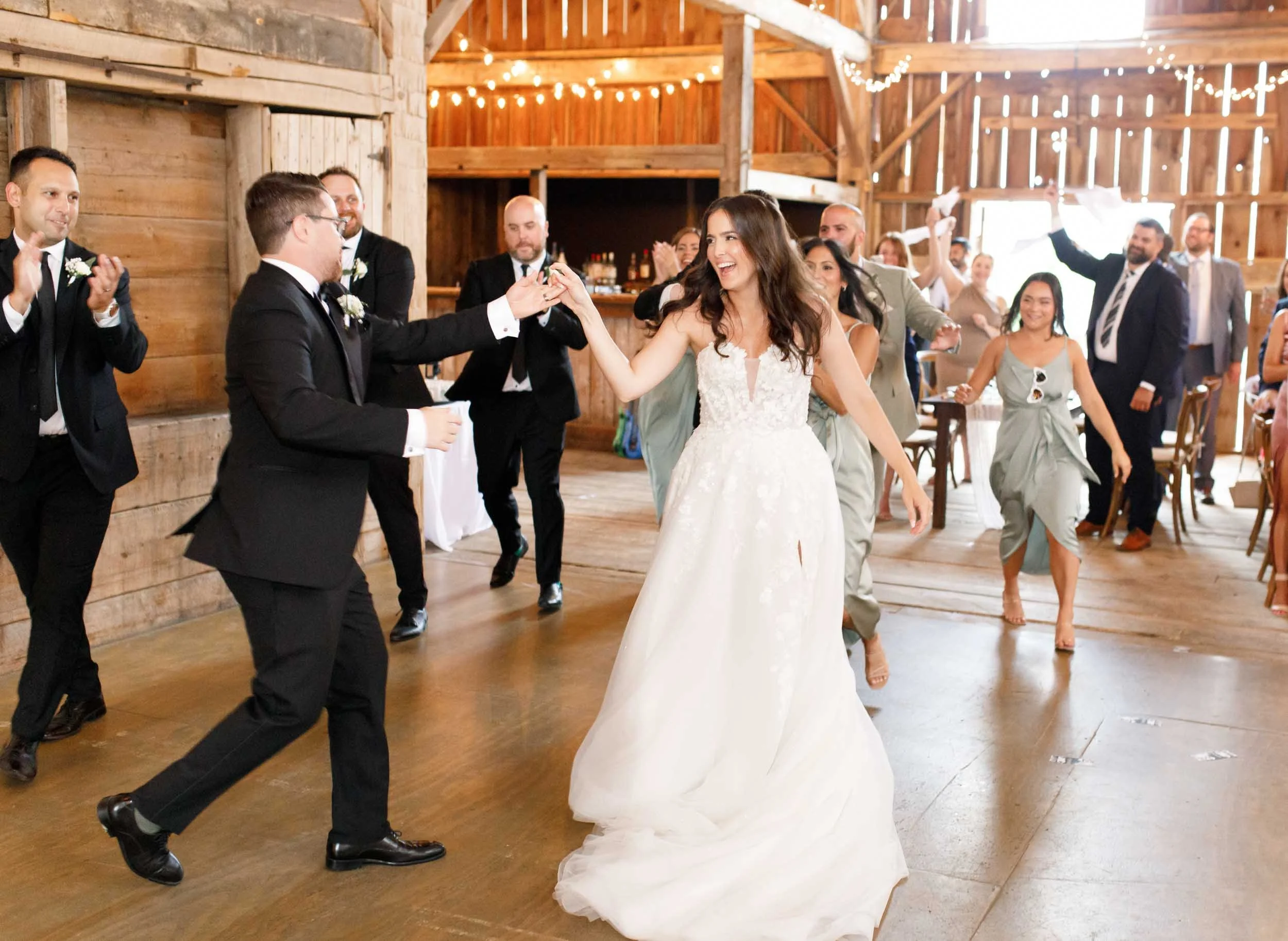 Bride and groom dancing with their wedding party at Cambium Farms in Alton, Ontario