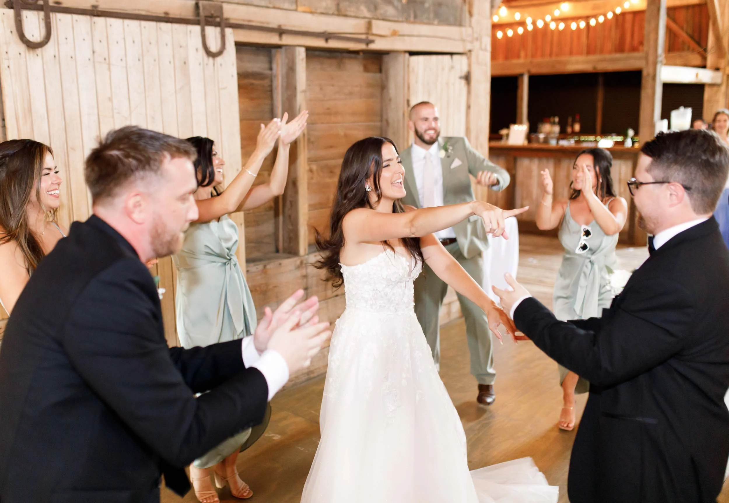 Bride dancing with guests during the wedding reception at Cambium Farms in Alton, Ontario