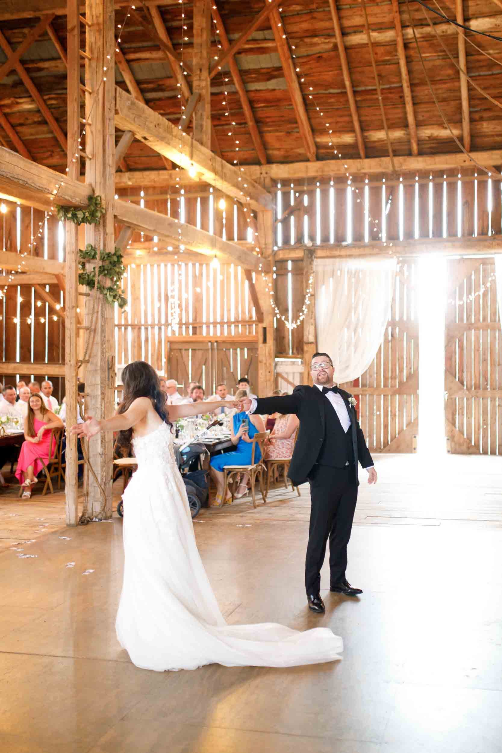 Wedding guests dancing inside the Cambium Farms barn in Alton, Ontario