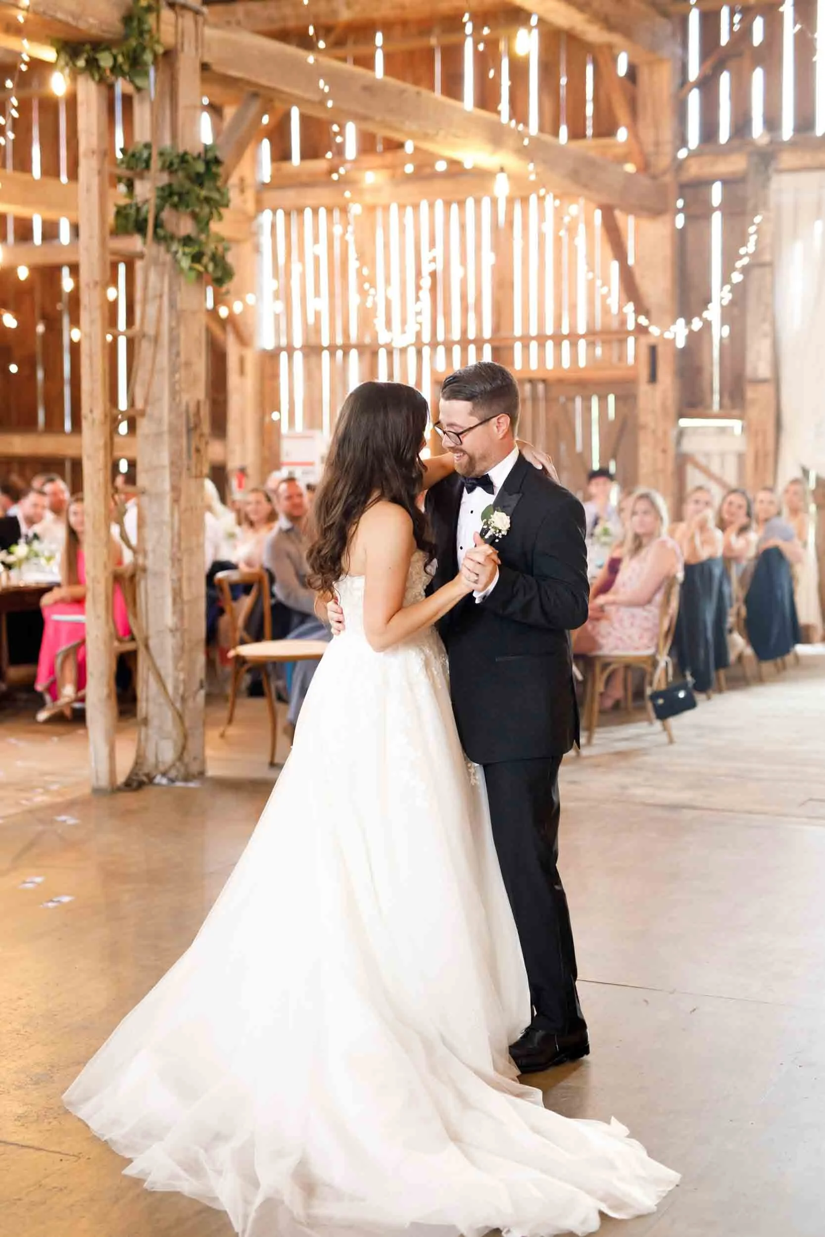 Bride and groom sharing their first dance inside the Cambium Farms barn in Alton, Ontario