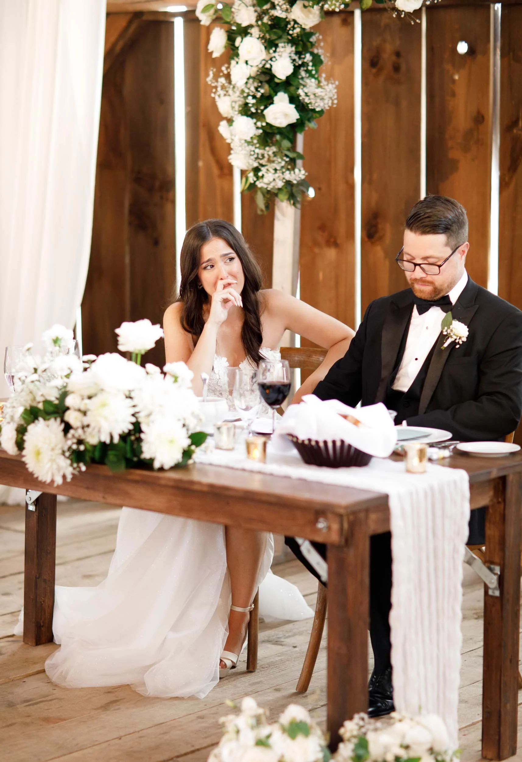 Bride and groom reacting to a speech at their Cambium Farms wedding in Alton, Ontario