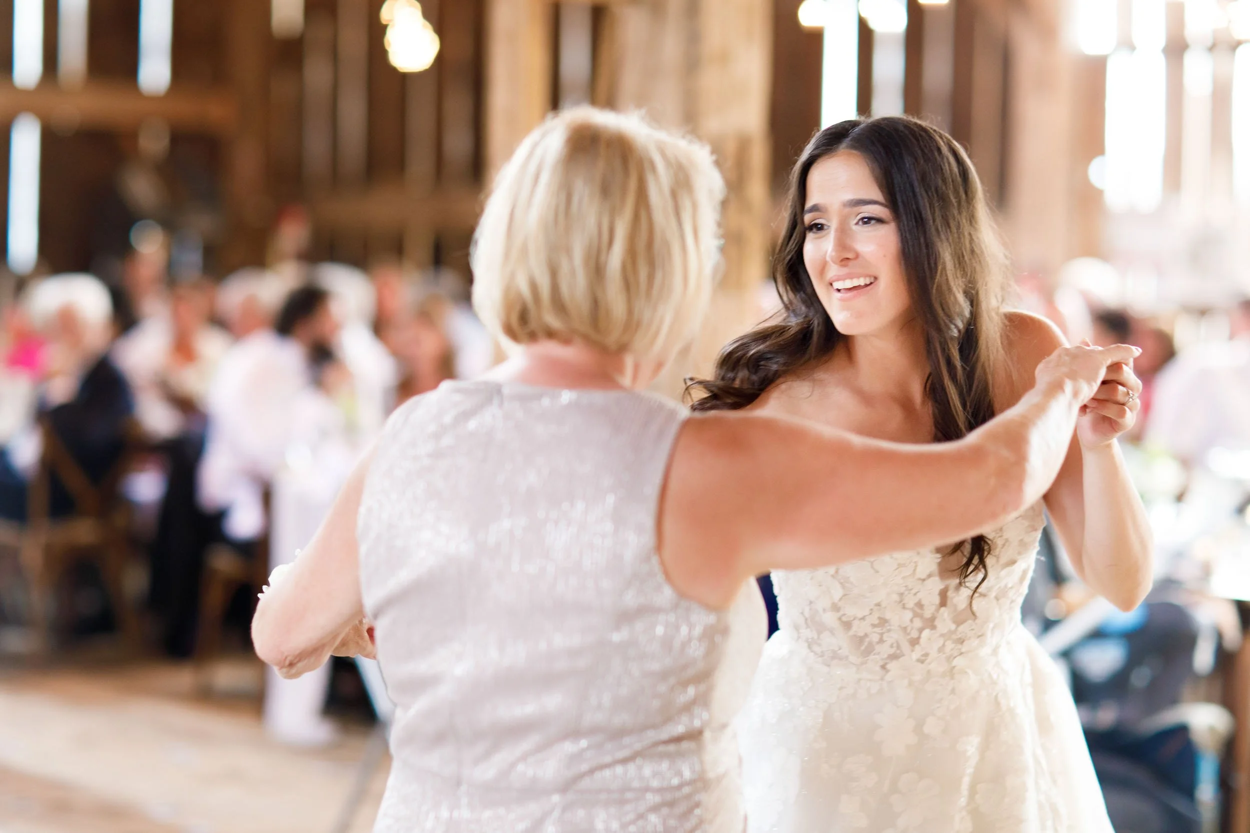 Bride dancing with her mother during the Cambium Farms wedding reception in Alton, Ontario