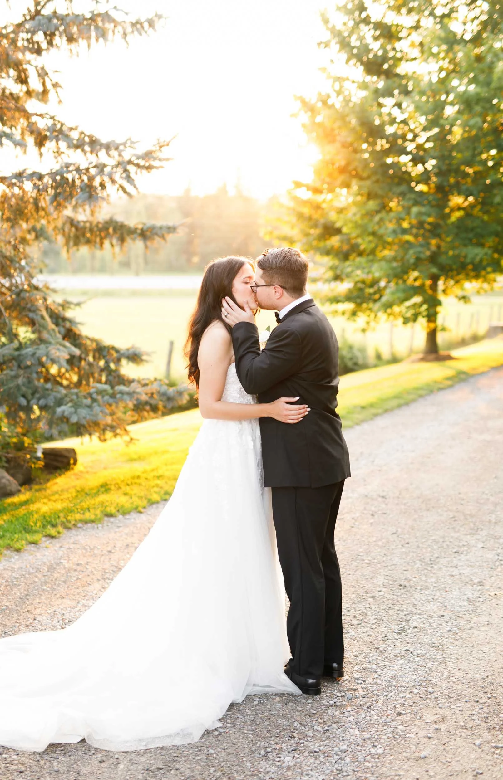 Bride and groom kissing during sunset portraits at Cambium Farms in Alton, Ontario