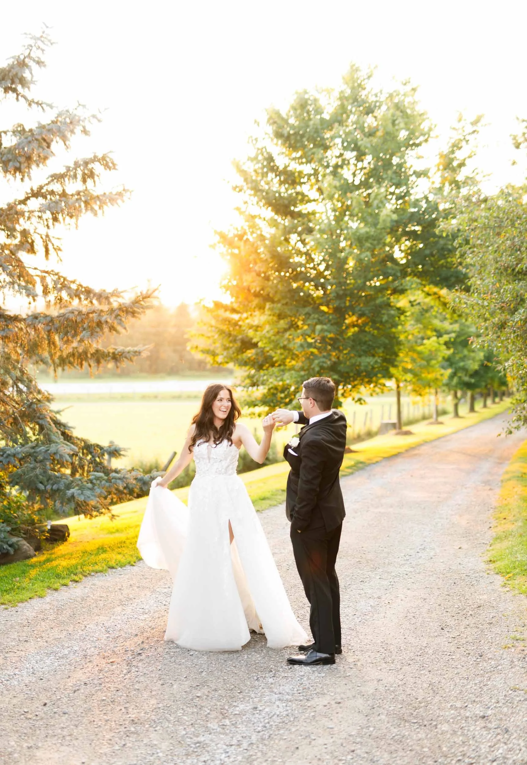 Bride and groom holding hands during sunset portraits at Cambium Farms in Alton, Ontario