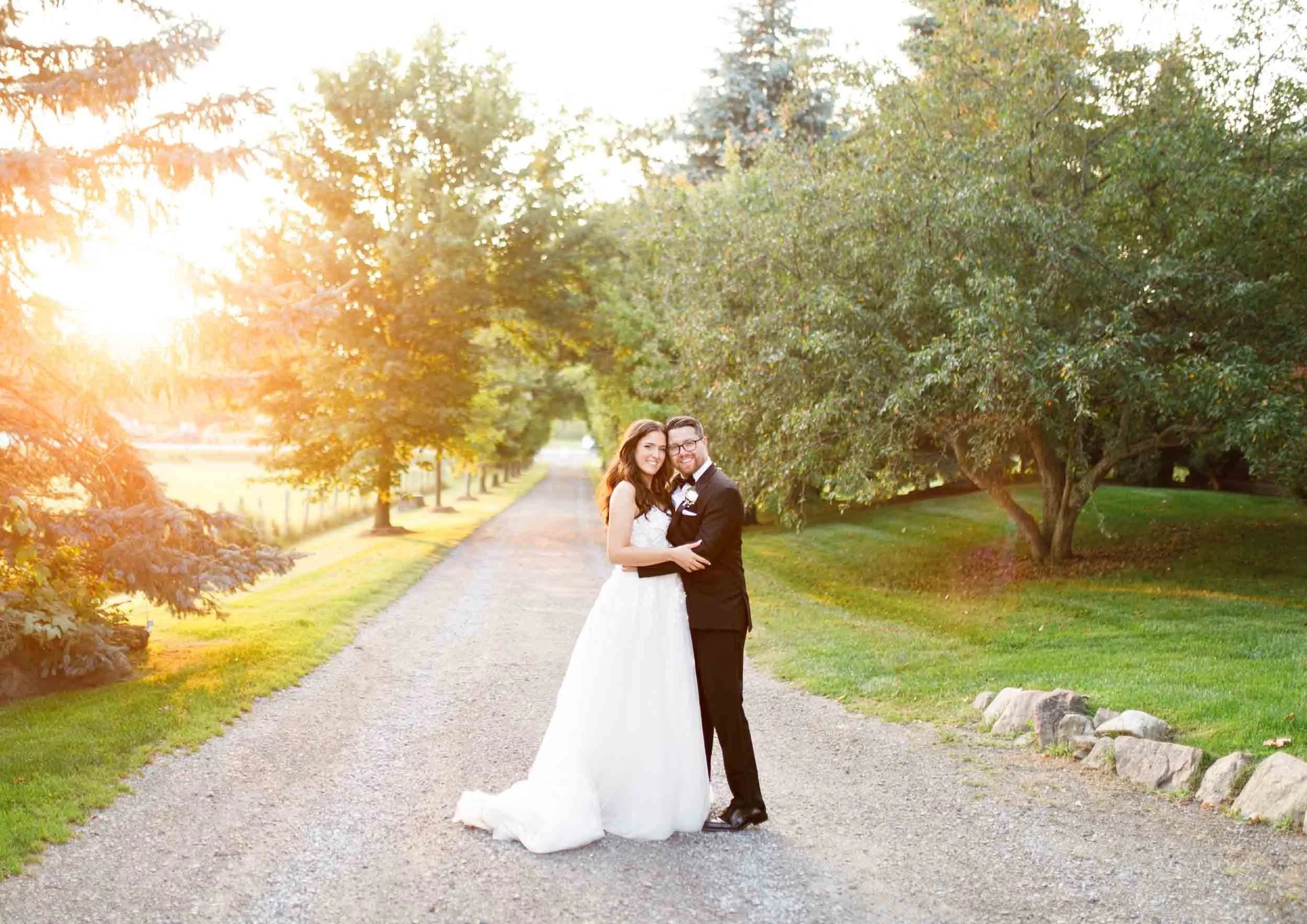 Bride and groom standing together in the sunset at a Cambium Farms wedding in Alton, Ontario