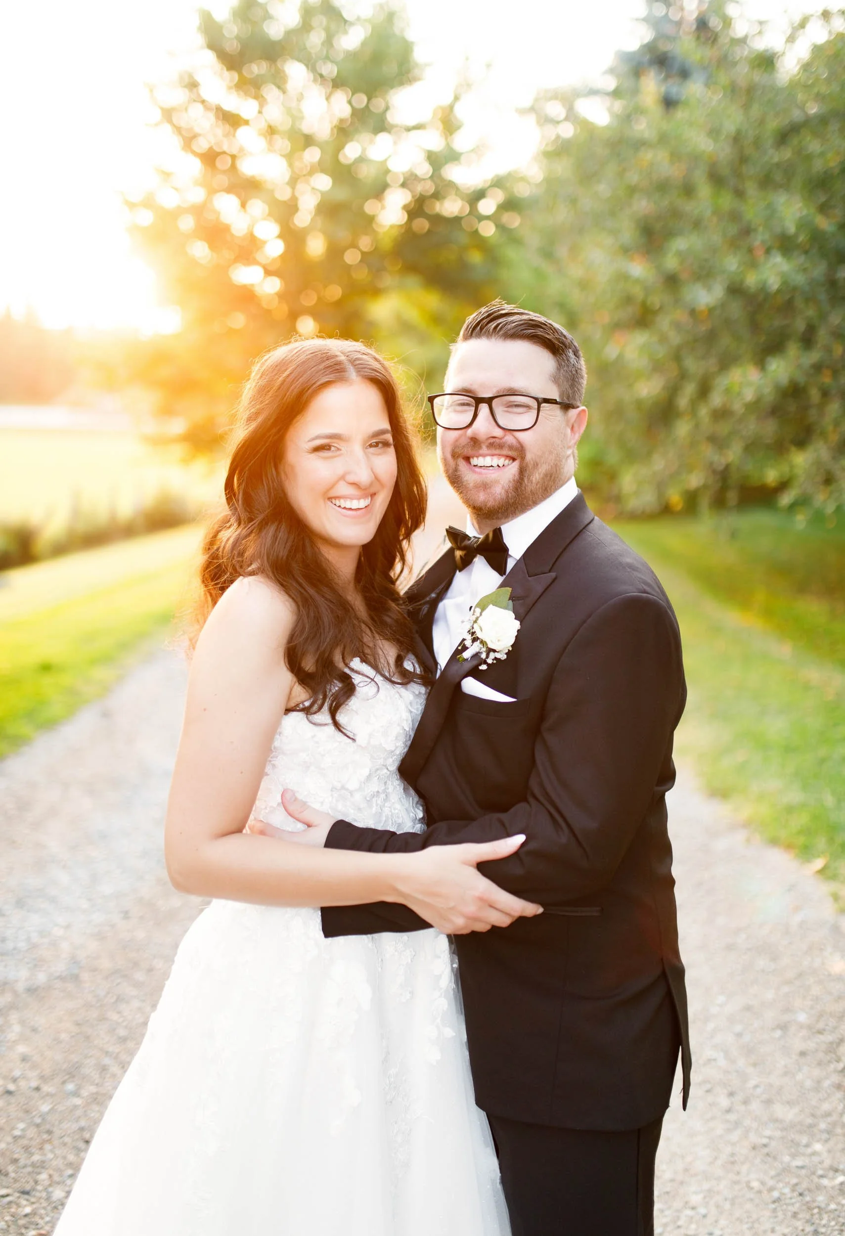 Bride and groom smiling together during golden hour at Cambium Farms in Alton, Ontario