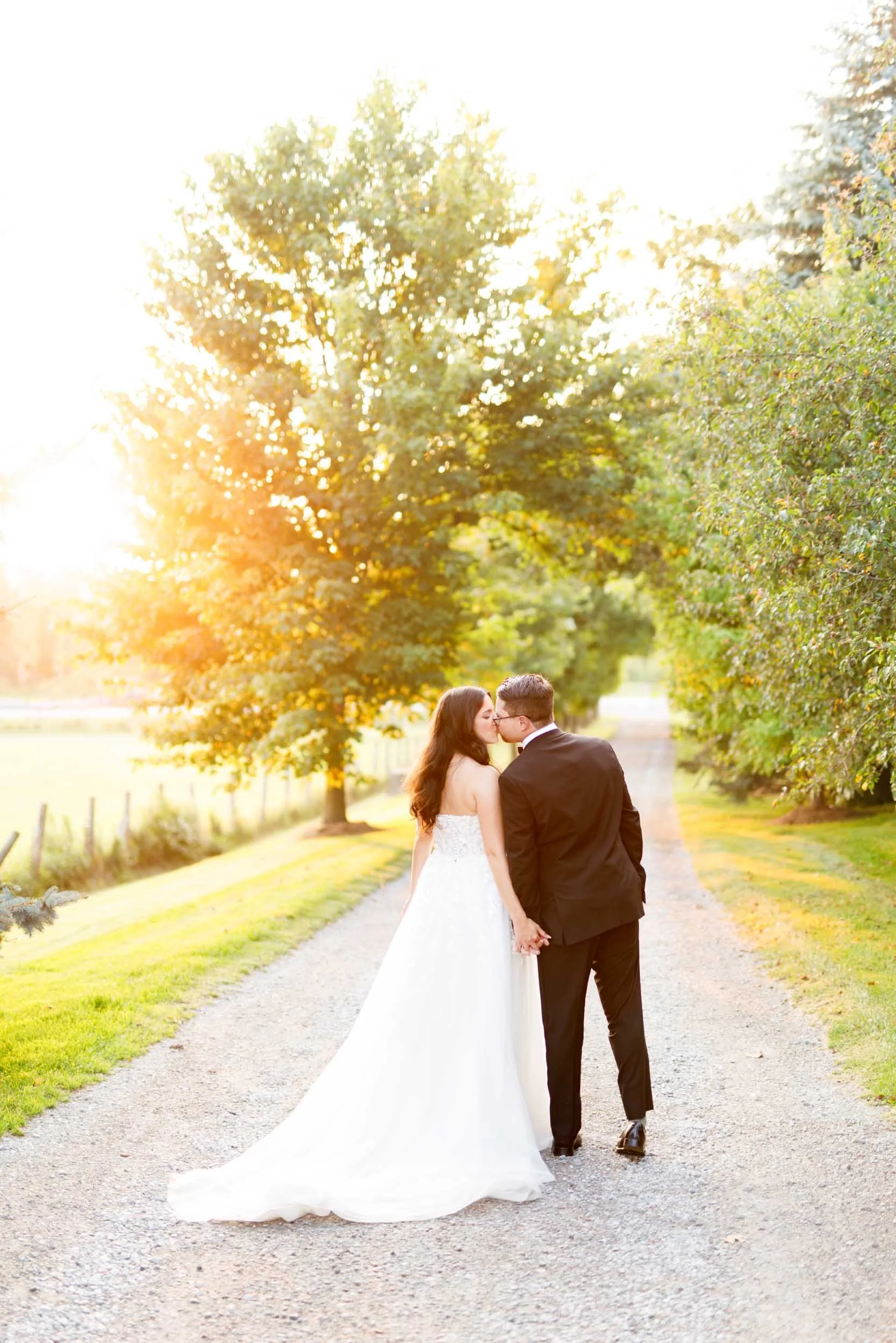 Bride and groom walking away together at sunset at Cambium Farms in Alton, Ontario