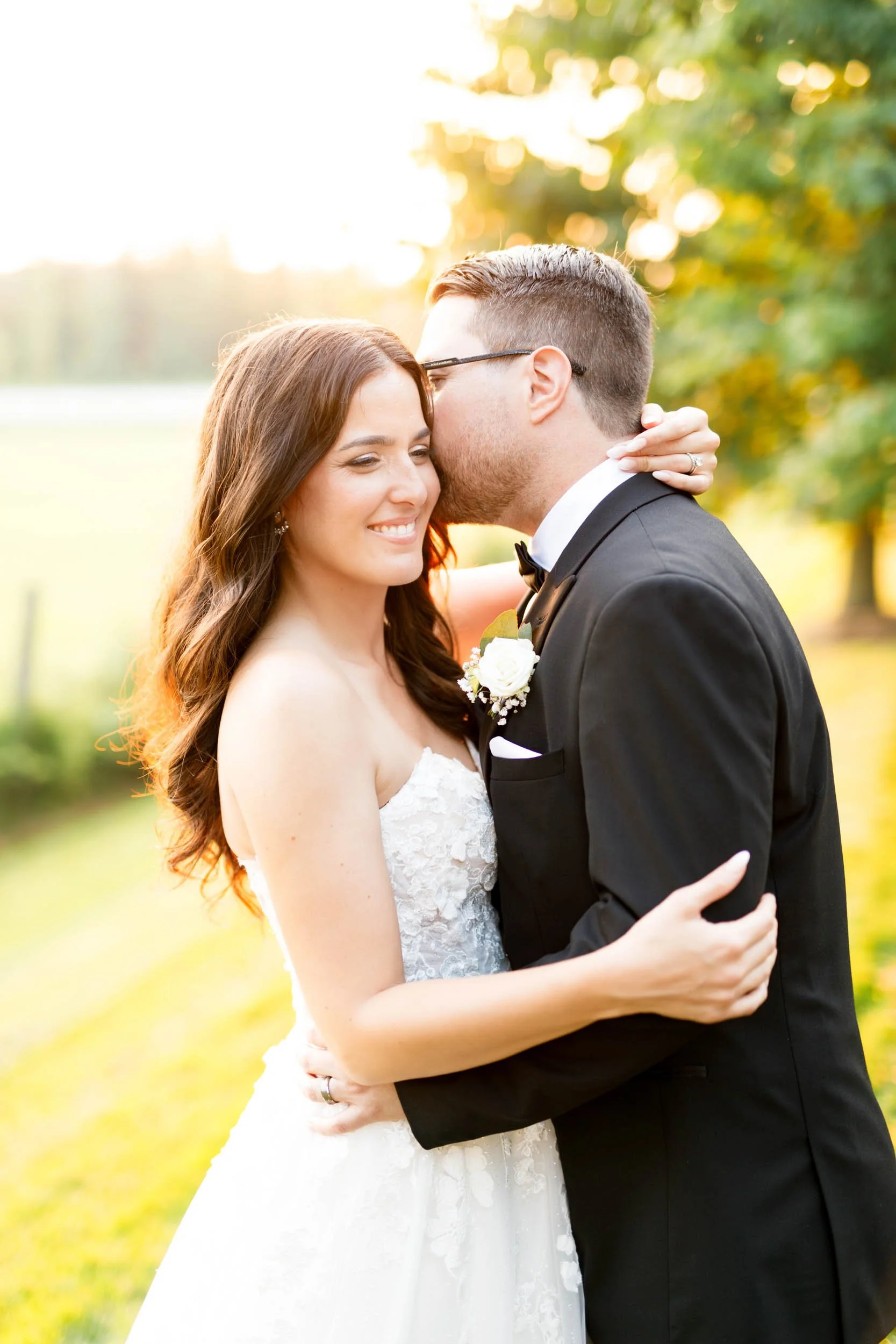 Bride and groom smiling together during sunset portraits at Cambium Farms in Alton, Ontario