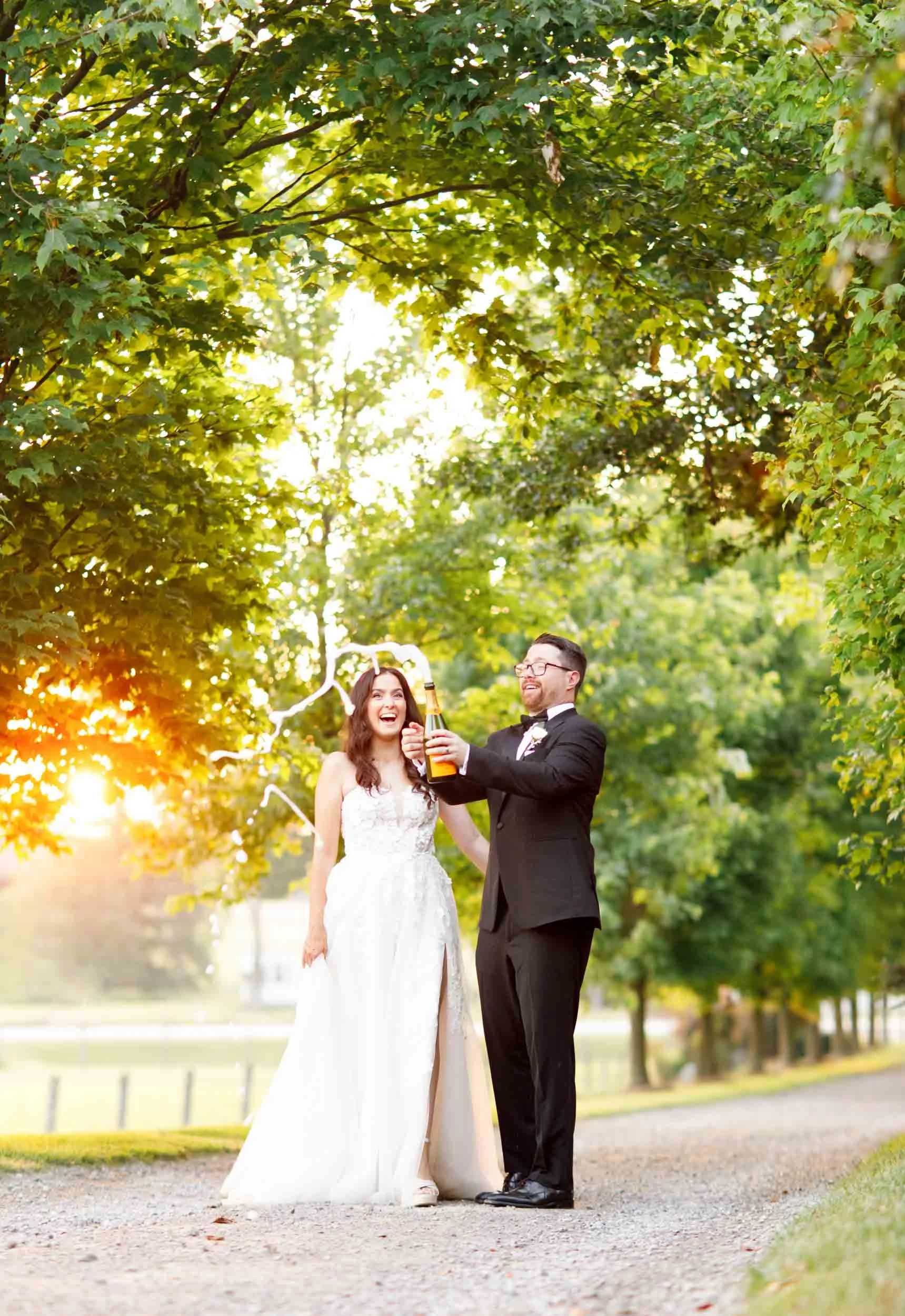 Newlyweds celebrating with champagne at sunset at Cambium Farms in Alton, Ontario