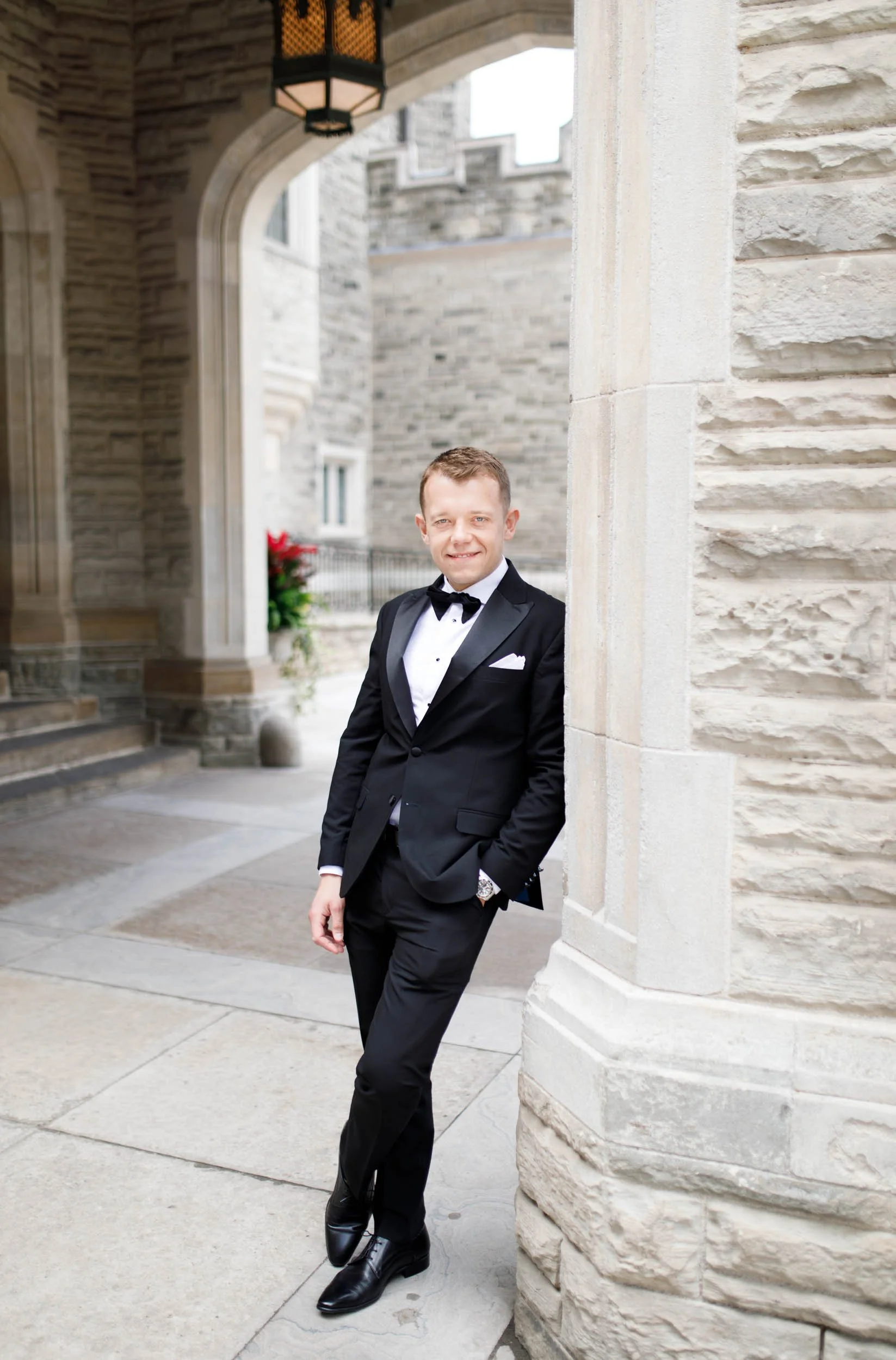Groom posing in the Casa Loma courtyard in Toronto