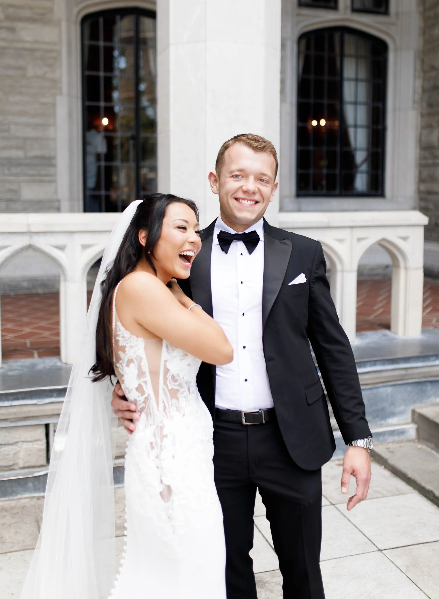 Bride laughing with the groom during their first look at Casa Loma in Toronto