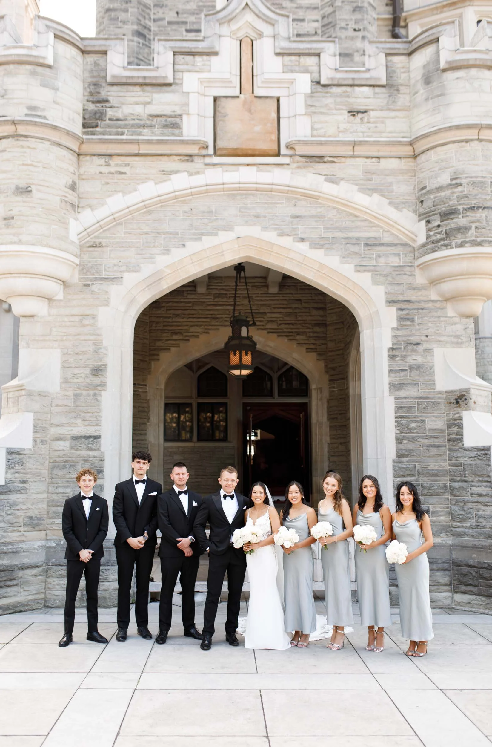Bridesmaids and groomsmen posing at Casa Loma in Toronto